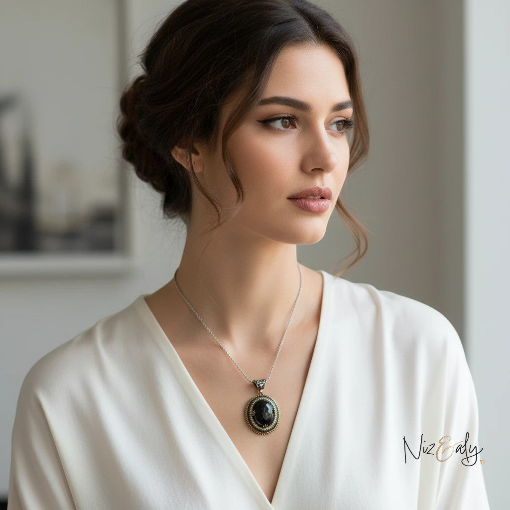Niz & Aly necklace featuring a large faceted black onyx pendant with VVS cubic zirconia stones on a woman