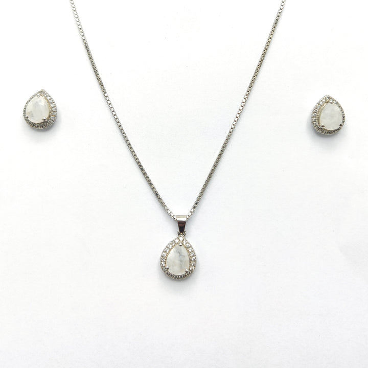 Niz & Aly blue flash moonstone pendant and earring set with silver halo settings on a white background