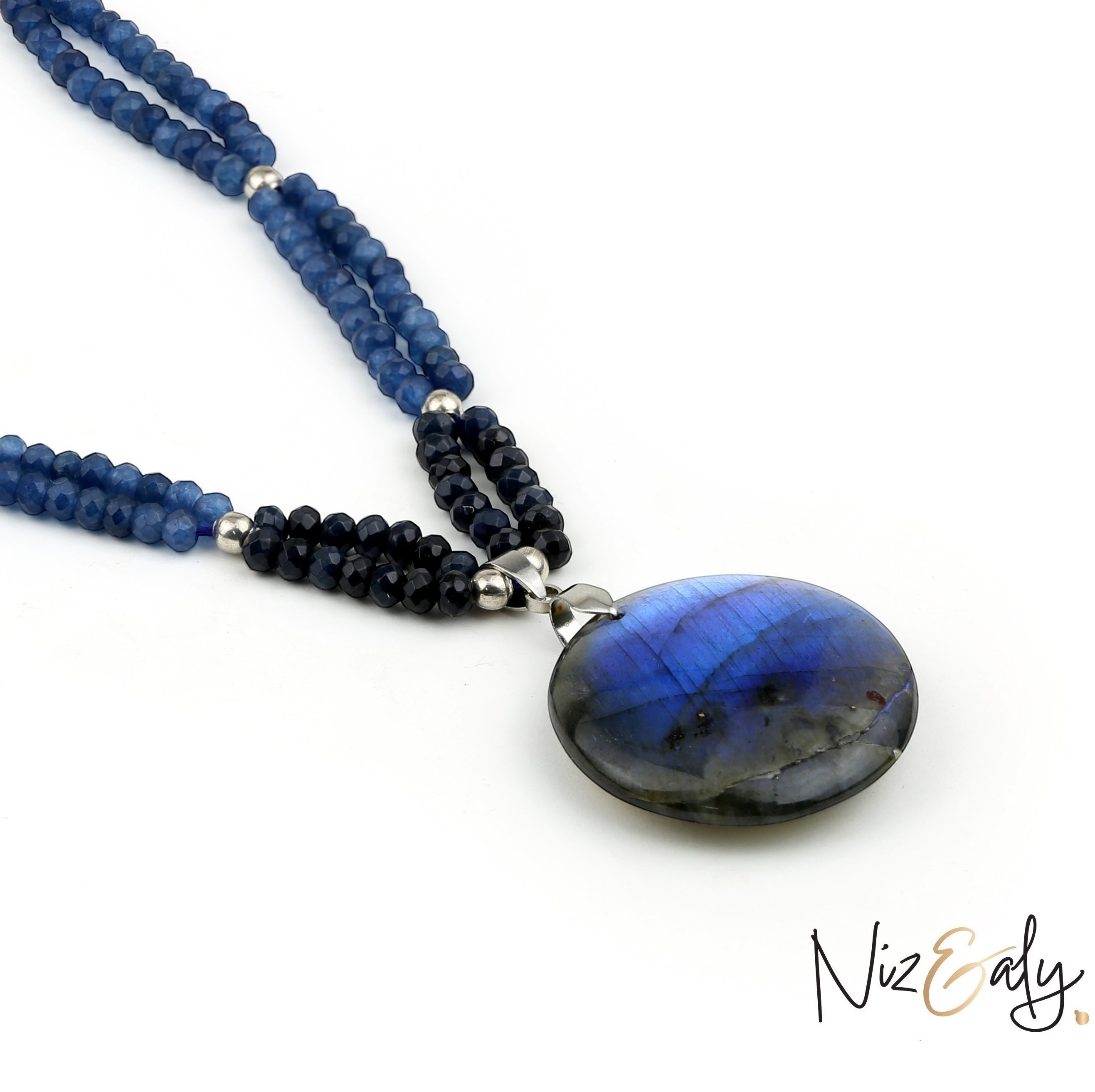 Niz & Aly necklace featuring blue gemstone beads and a large iridescent labradorite pendant on a white background