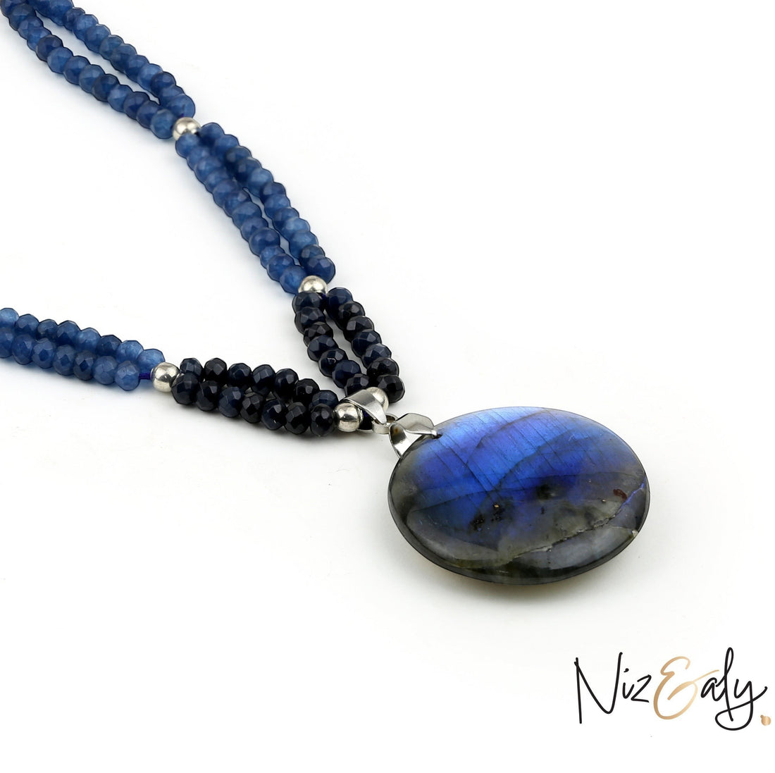 Niz & Aly necklace featuring blue gemstone beads and a large iridescent labradorite pendant on a white background