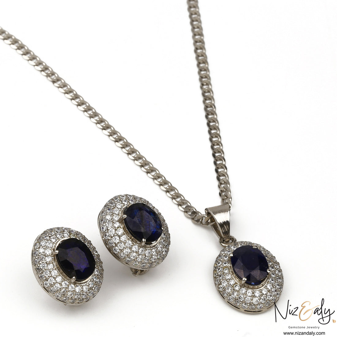 Niz & Aly royal blue oval sapphire pendant and matching stud earring set with diamond halo in silver setting