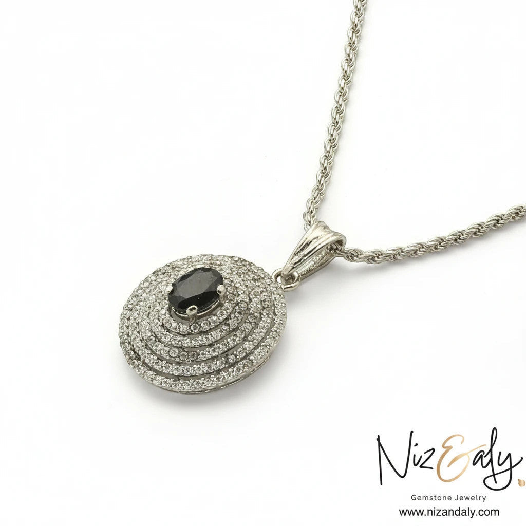 Niz & Aly Celestial Sapphire pendant necklace featuring a deep blue oval sapphire surrounded by concentric stone halos.