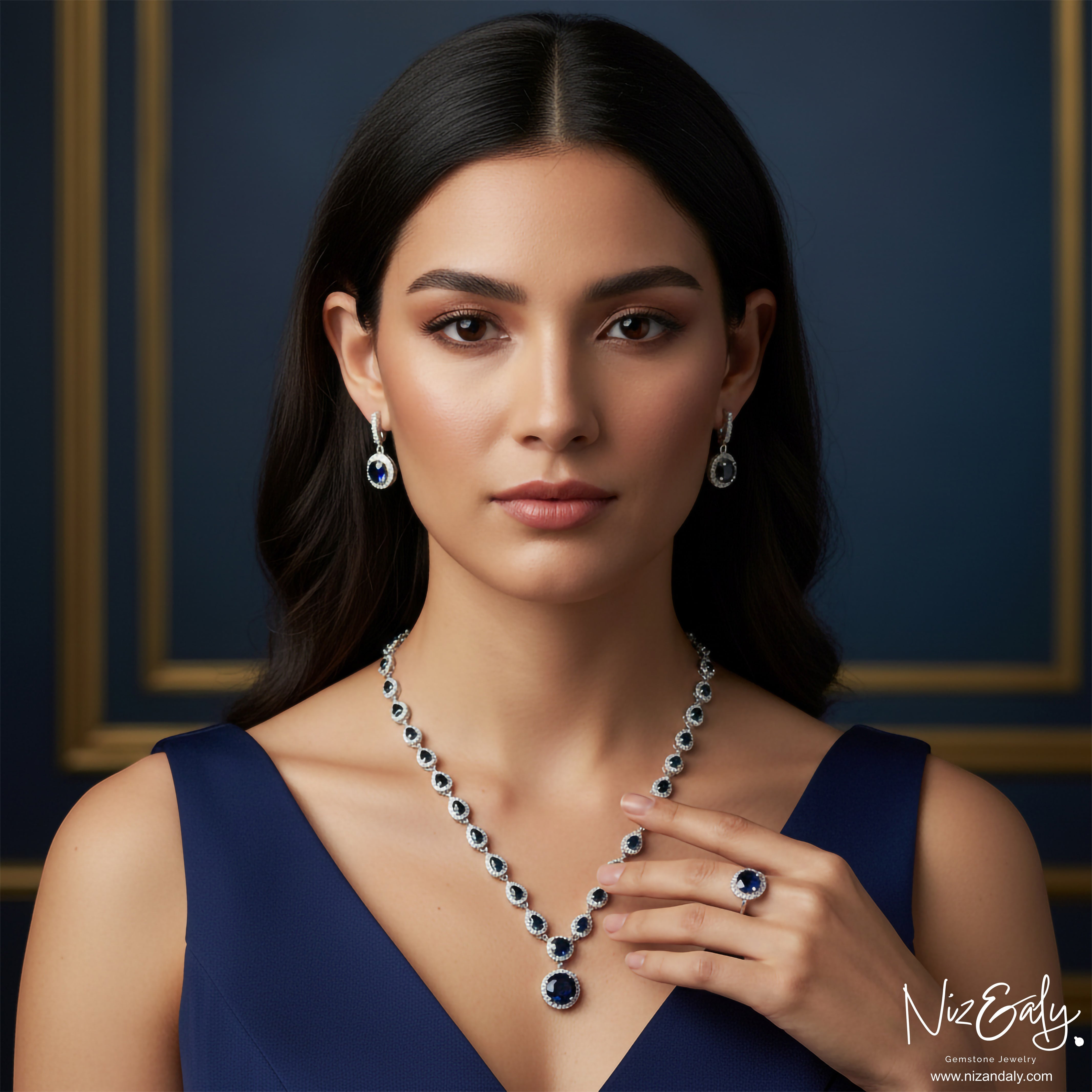 Niz & Aly blue sapphire and sterling silver jewelry set featuring a necklace, drop earrings, and ring on a woman.