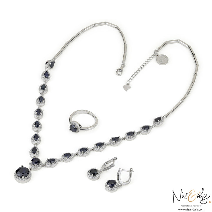 Niz & Aly blue sapphire and 925 sterling silver jewelry set featuring a teardrop necklace, matching earrings, and ring.