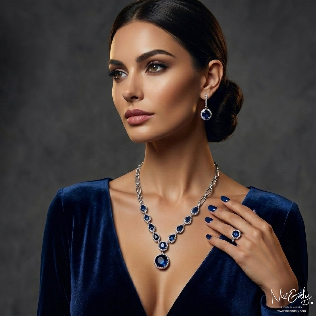 Niz & Aly blue sapphire and sterling silver jewelry set featuring a necklace, drop earrings, and ring on a model.