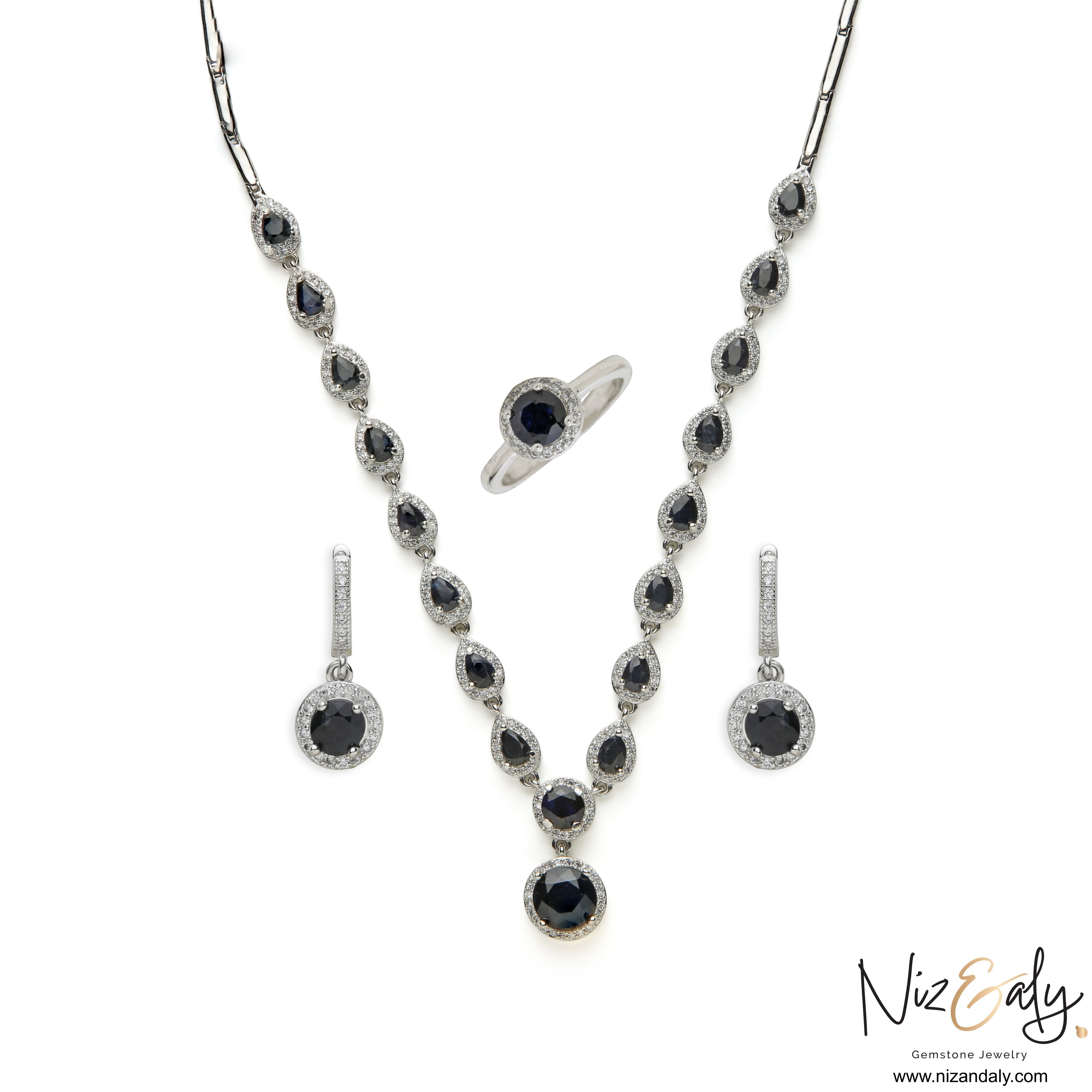 Niz & Aly blue sapphire and sterling silver jewelry set featuring a necklace, drop earrings, and a matching ring.
