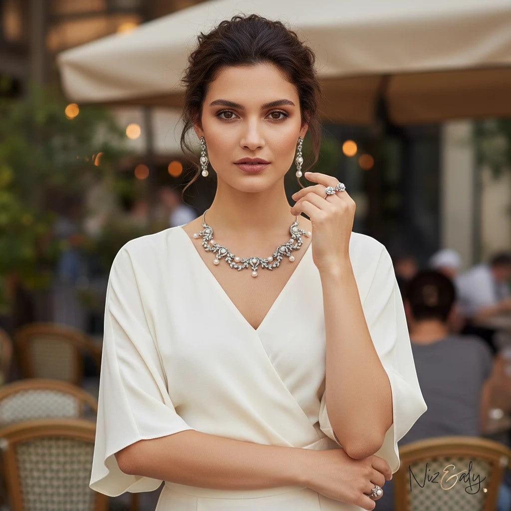 Niz & Aly bridal freshwater pearl necklace and earring set in sterling silver worn by a woman in a white dress.