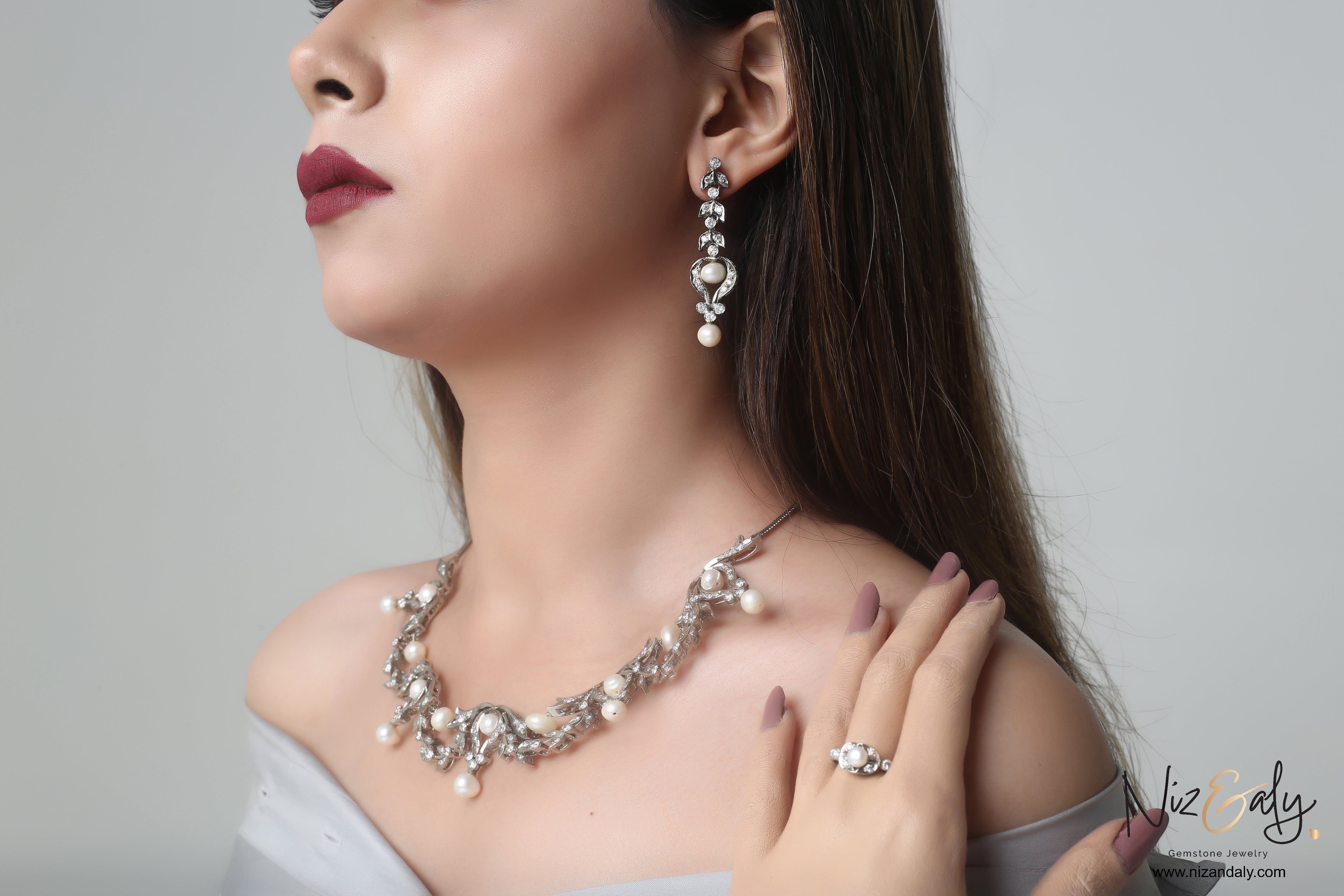 Niz & Aly bridal freshwater pearl necklace and earring set in sterling silver worn by a model