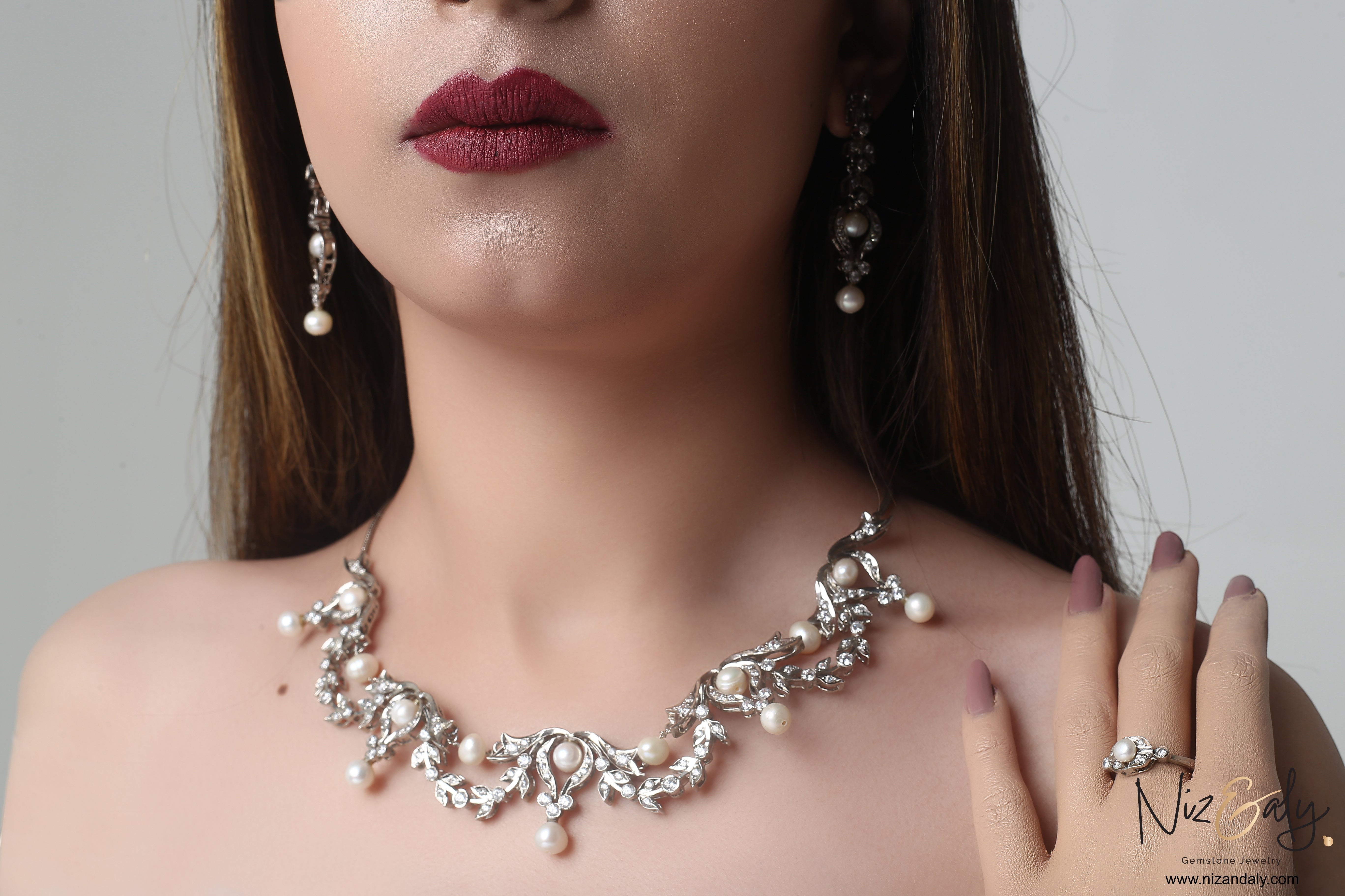 Niz & Aly bridal freshwater pearl necklace set with sterling silver filigree and matching earrings on a model