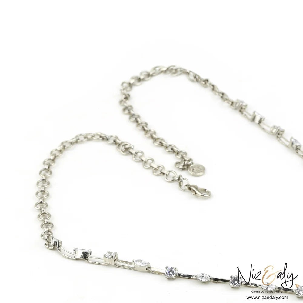 Niz & Aly brown agate statement necklace featuring a silver chain accented with sparkling cubic zirconia stones.