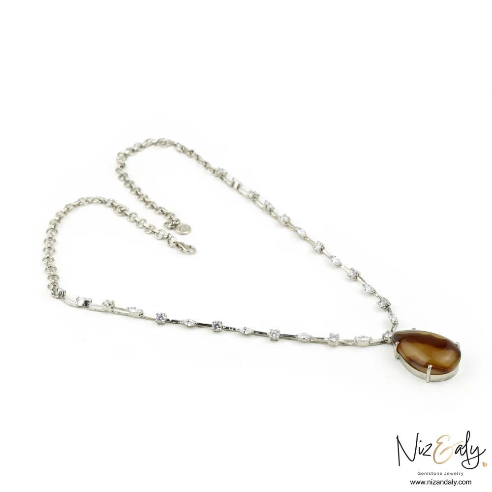 Niz & Aly brown agate statement necklace with cubic zirconia studded silver chain on a white background