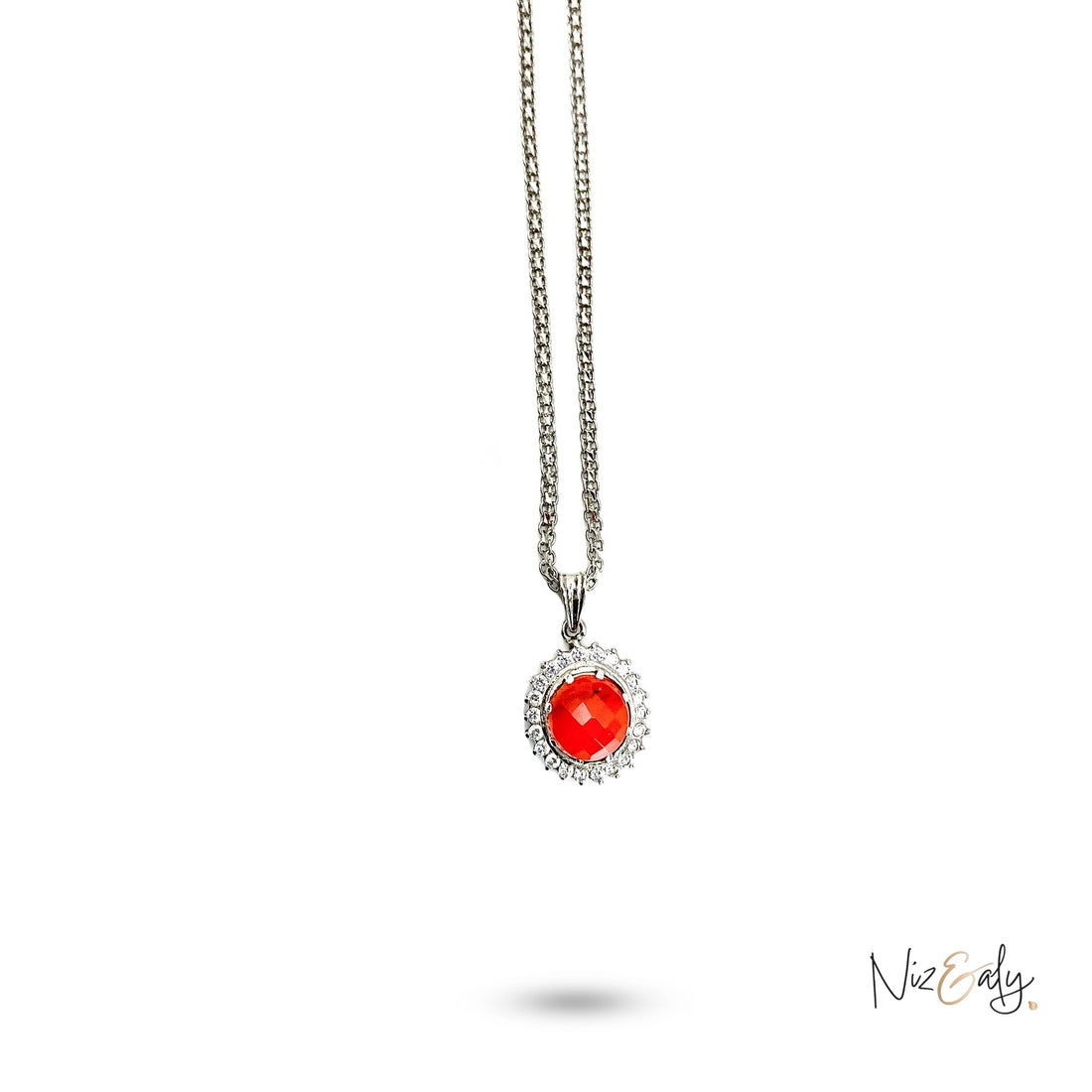 Niz & Aly radiant carnelian locket featuring a vibrant orange-red stone surrounded by a halo of sparkling crystals