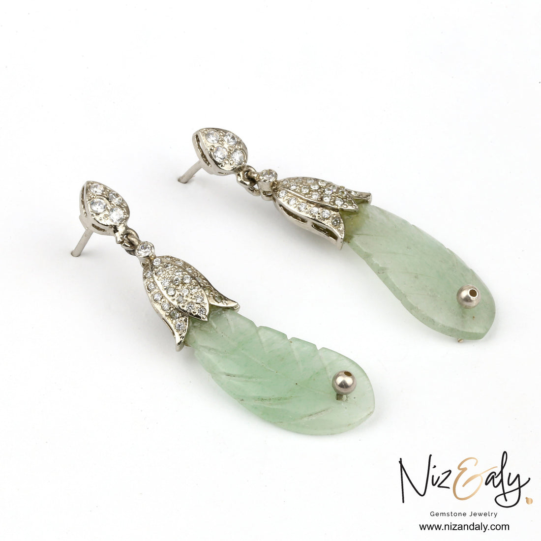 Niz & Aly carved pale green prehnite leaf-shaped drop earrings with sparkling pavé set crystals in silver settings.