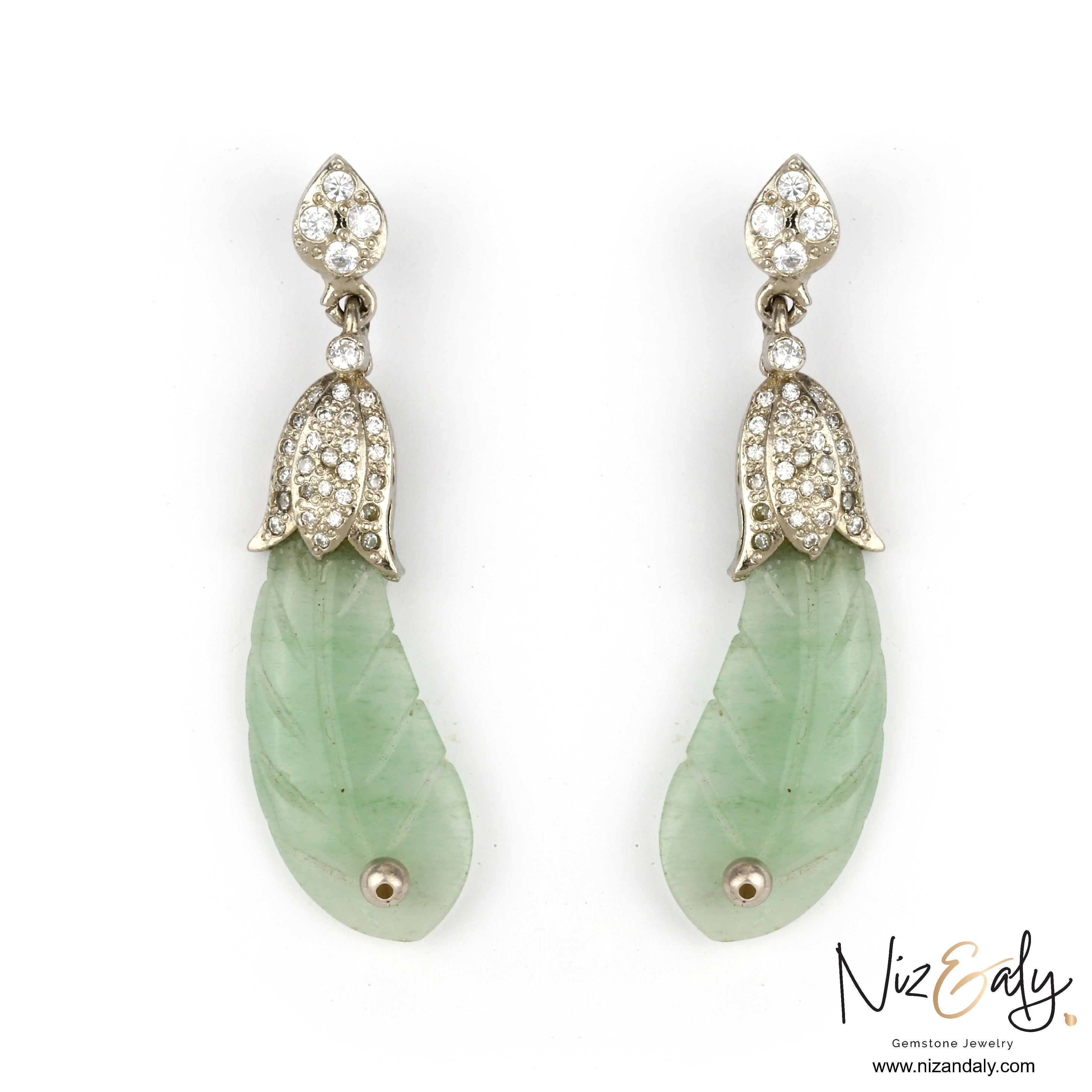 Niz & Aly carved prehnite leaf-shaped drop earrings with diamond-encrusted silver caps on a white background.