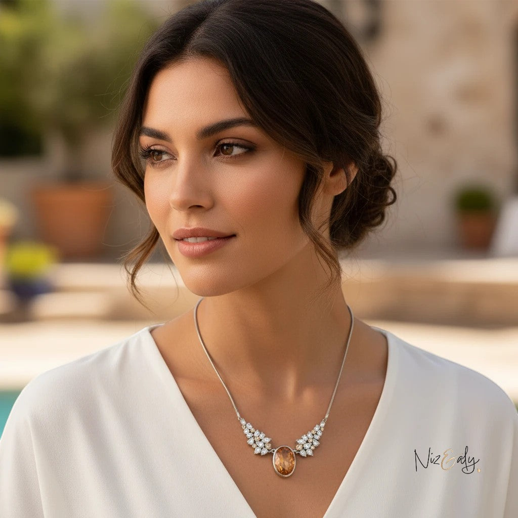 Niz & Aly statement necklace featuring a champagne-hued zirconia pendant with sparkling accents on a woman