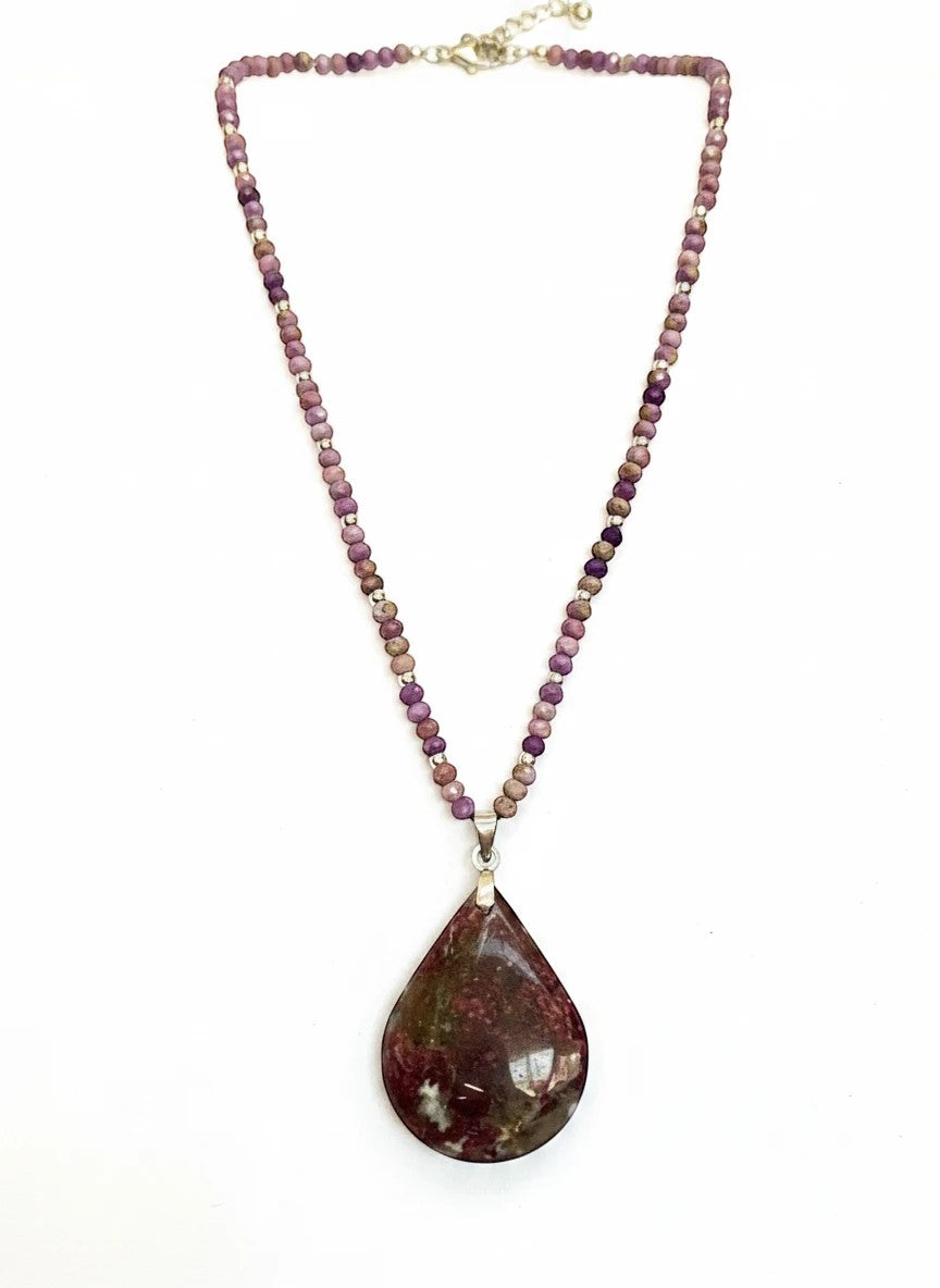 Niz & Aly teardrop Charoite pendant necklace with purple, lavender, and beige beaded chain on a white background.