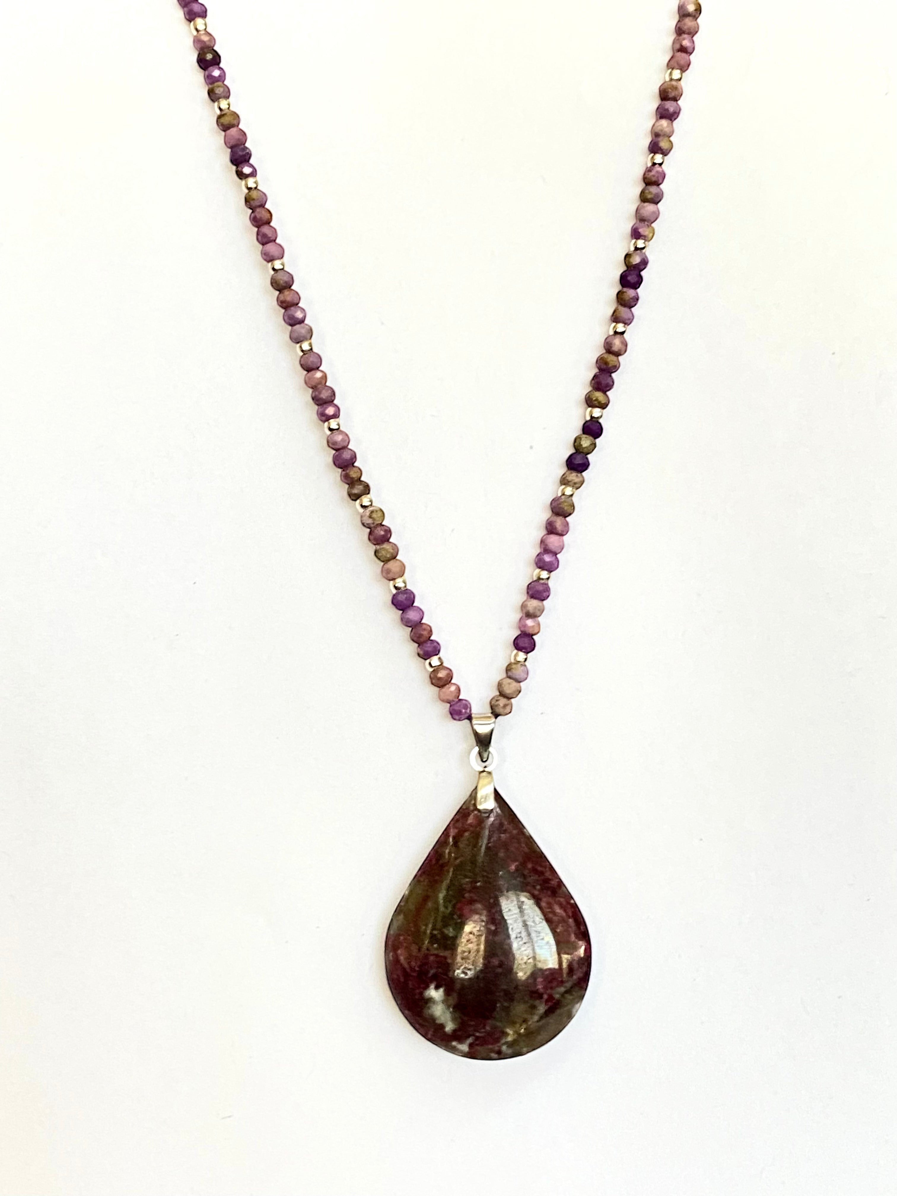 Niz & Aly teardrop Charoite pendant necklace with purple, lavender, and beige beaded chain on a white background.