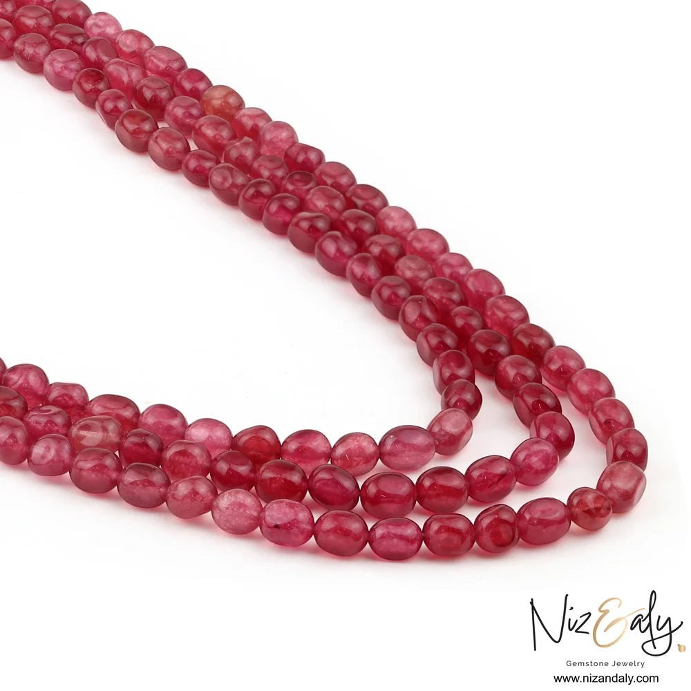 Niz & Aly triple strand necklace featuring polished translucent cherry quartz beads in a fluid rope design.