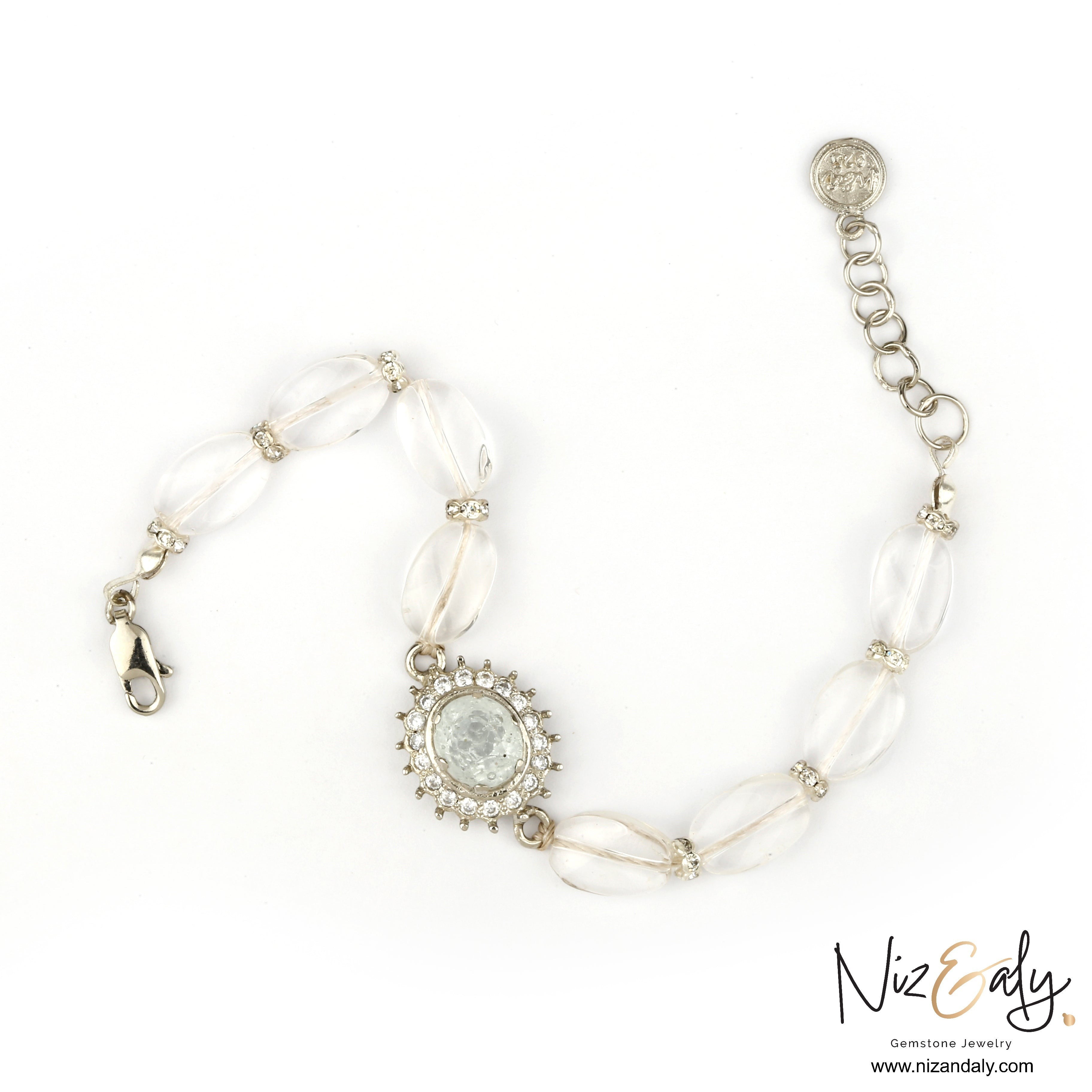Niz & Aly clear quartz beaded bracelet featuring polished oval crystals and a central rhinestone halo charm.