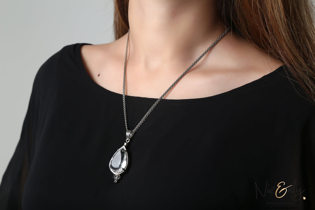 Niz & Aly Moonlight Whisper pendant featuring a clear quartz drop and black onyx stones on a silver chain