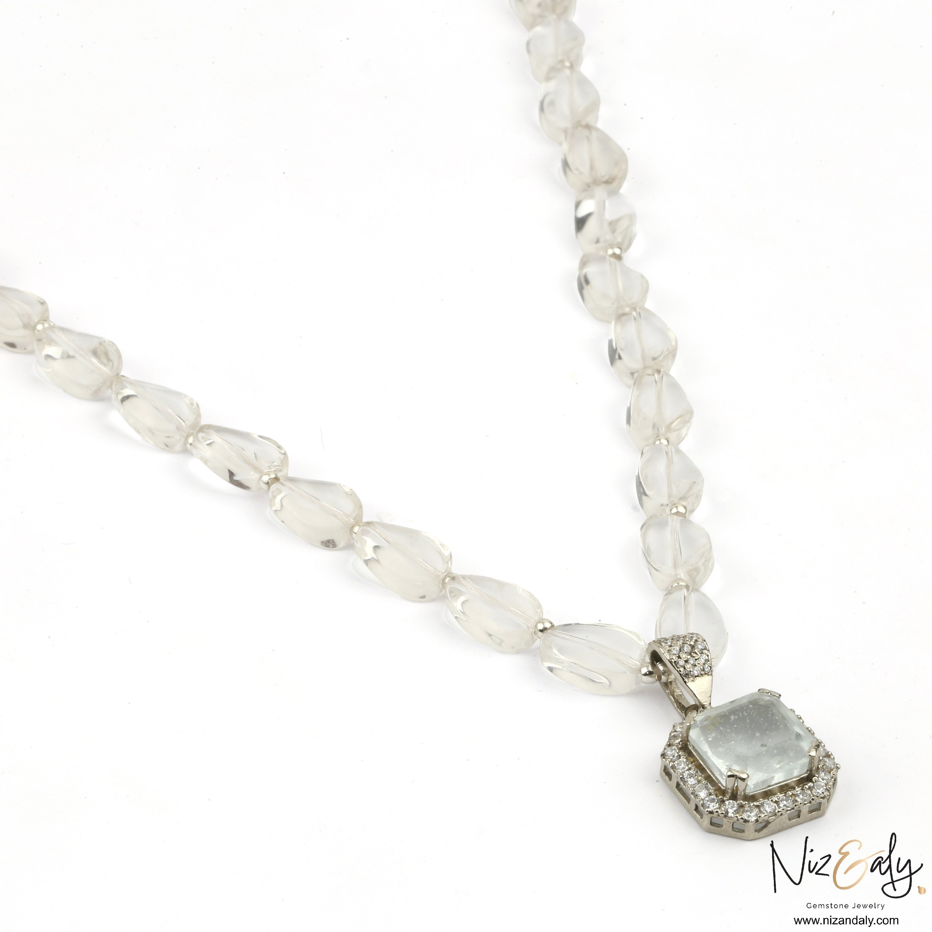 Niz & Aly clear quartz pendant necklace with icy quartz beads and a diamond-accented frame on a white background