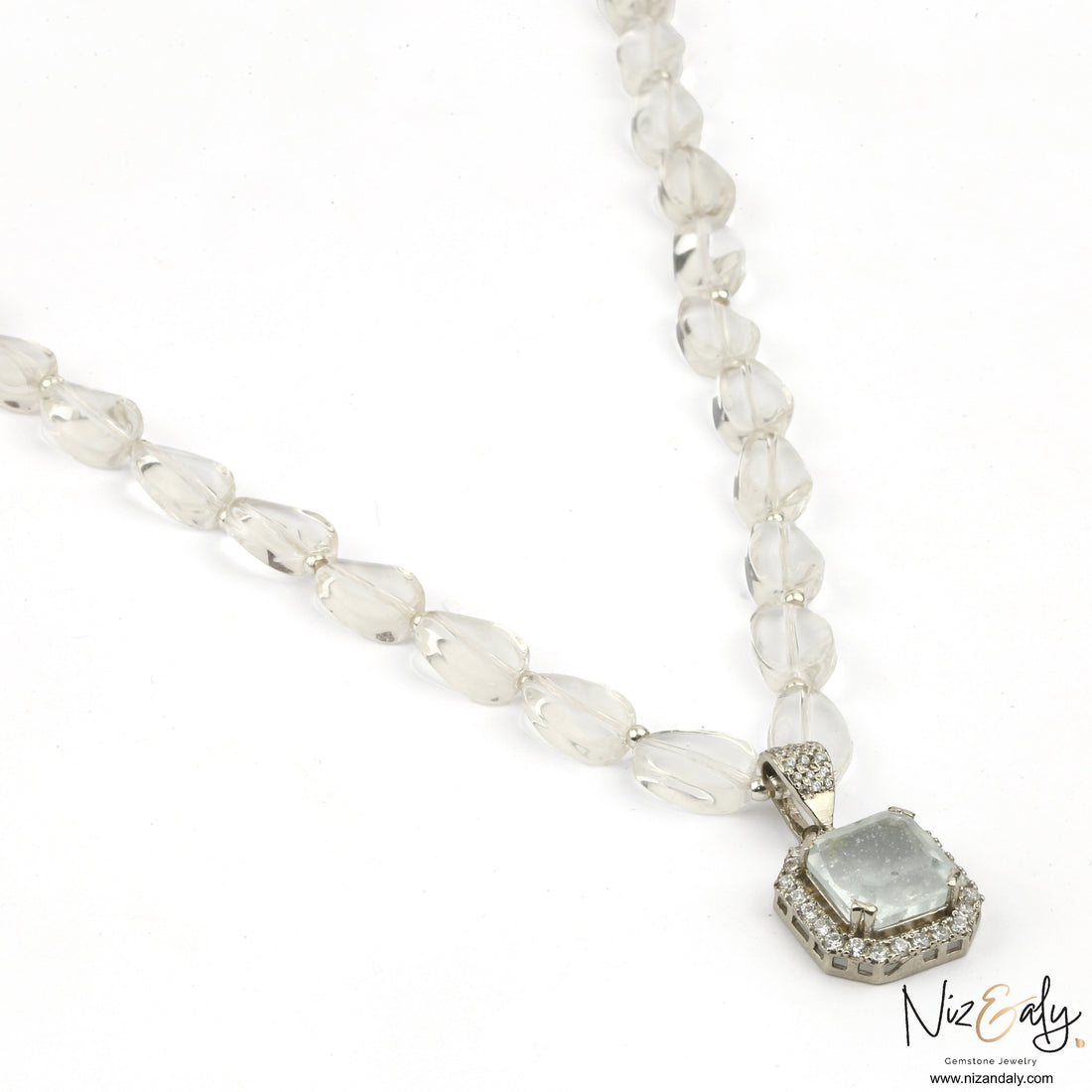 Niz & Aly clear quartz pendant necklace with icy quartz beads and a diamond-accented frame on a white background