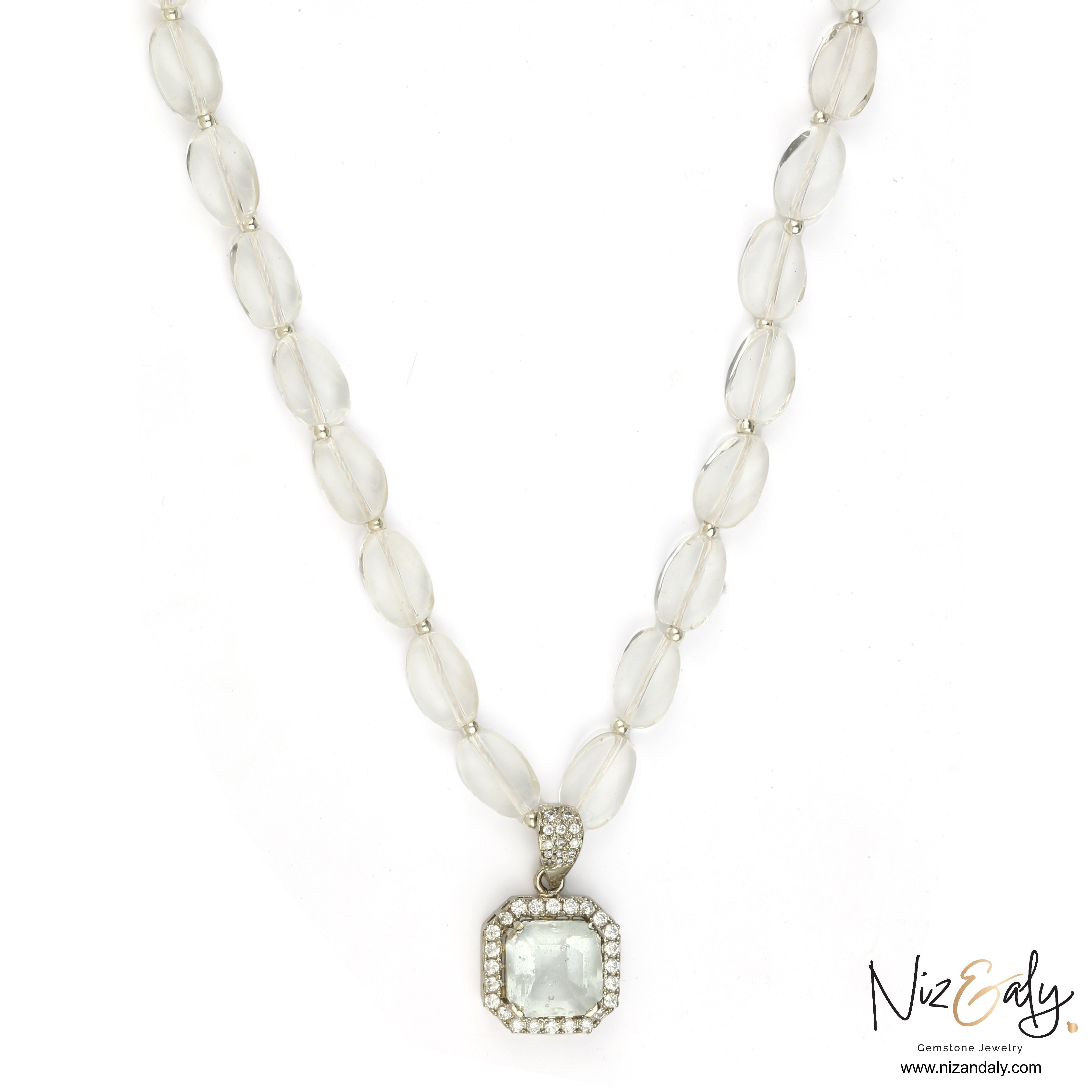 Niz & Aly clear quartz pendant necklace with icy quartz beads and a diamond-accented frame on a white background.