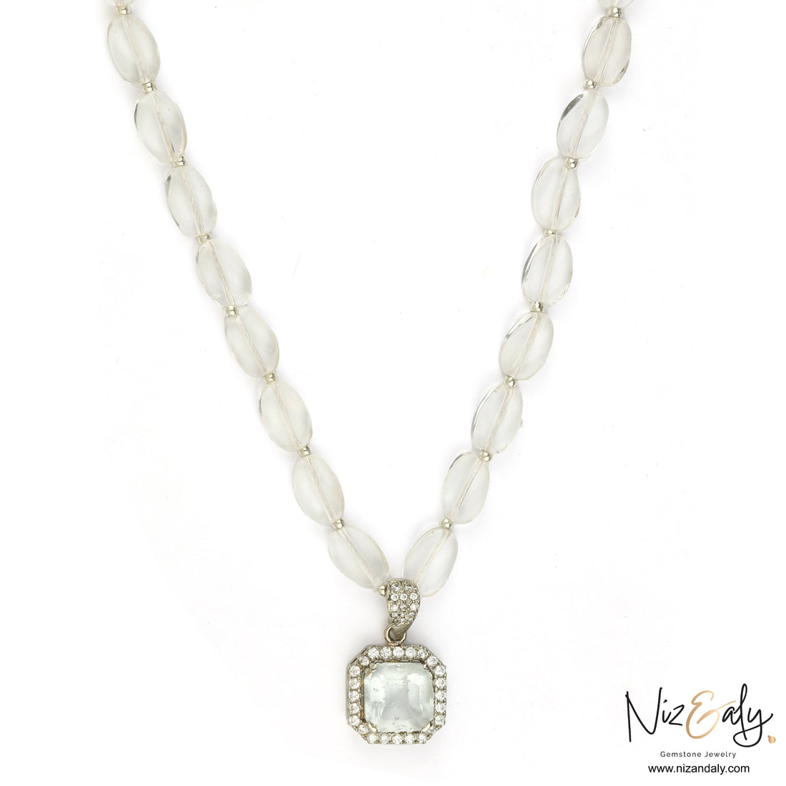 Niz & Aly clear quartz pendant necklace with icy quartz beads and a diamond-accented frame on a white background.