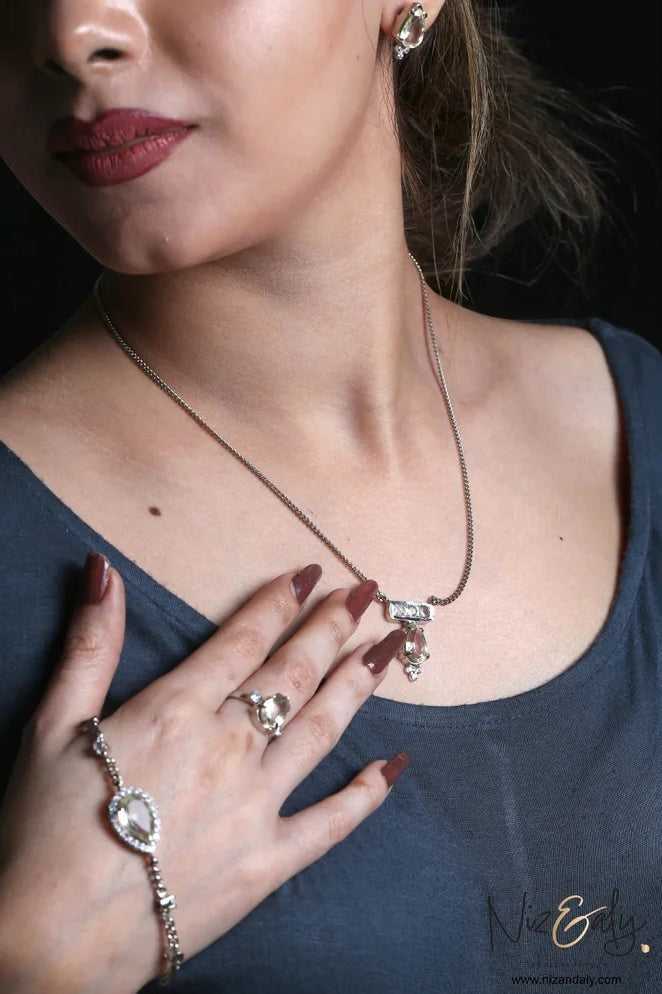 Niz & Aly clear quartz pendant necklace, ring, and bracelet set in 925 sterling silver worn by a model