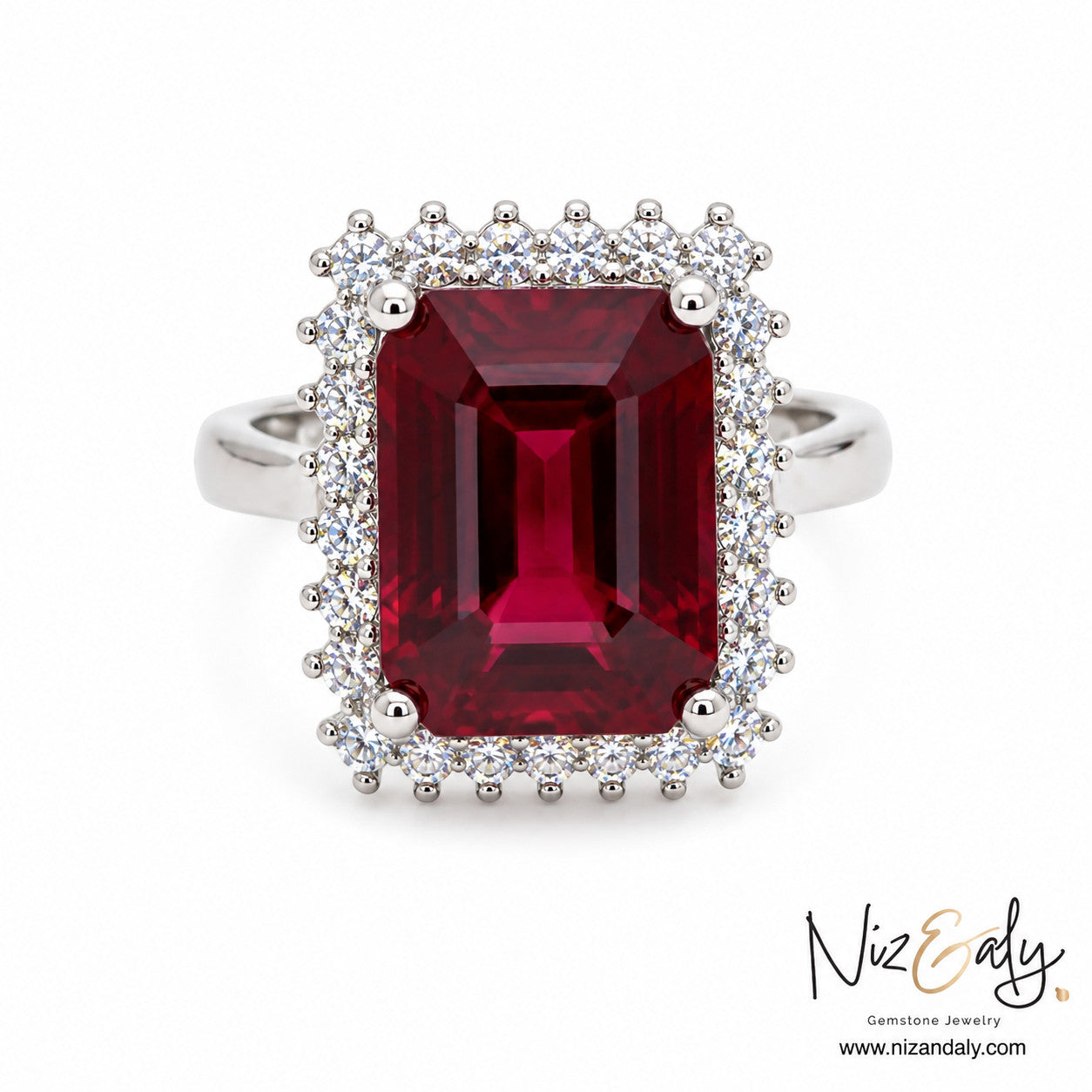 Niz & Aly emerald-cut natural ruby ring surrounded by a halo of sparkling diamonds on a polished silver band.