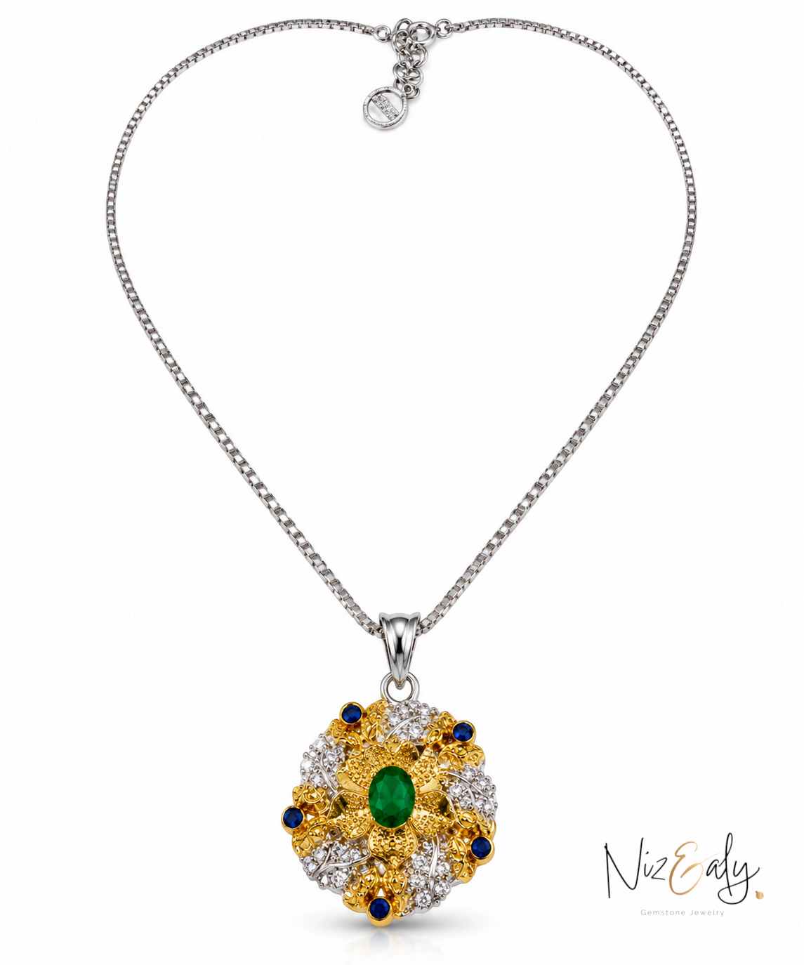 Niz & Aly emerald and diamond pendant necklace featuring a central oval green gemstone in a gold and silver floral setting