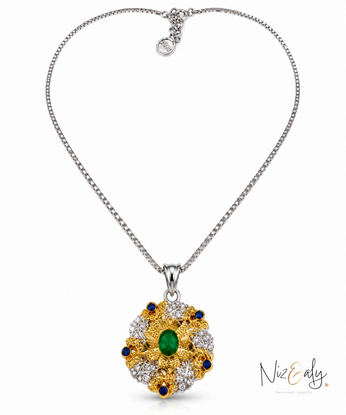 Niz & Aly emerald and diamond pendant necklace featuring a central oval green gemstone in a gold and silver floral setting