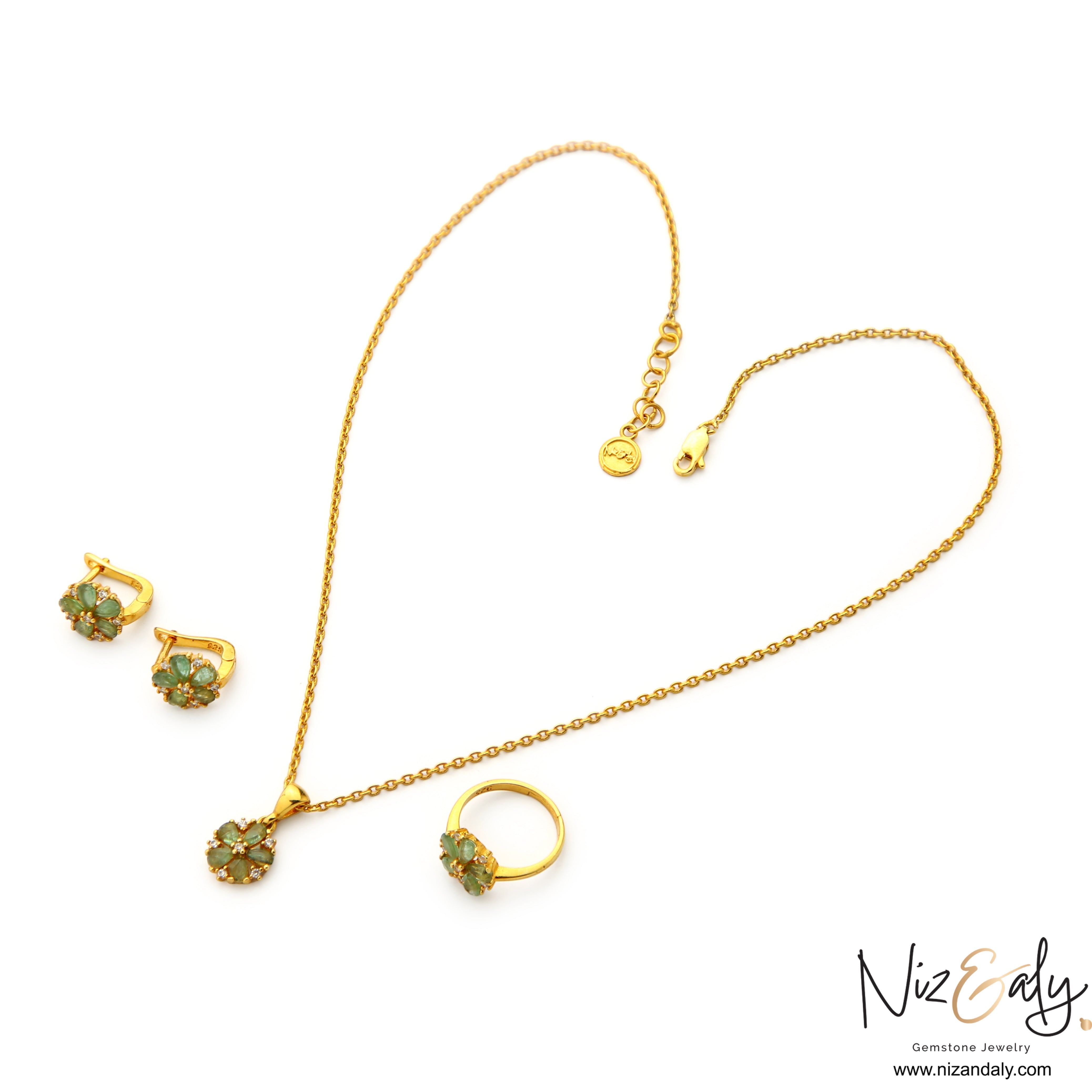 Niz & Aly floral pendant necklace, earrings, and ring set featuring natural emeralds and clear stones in gold plating.