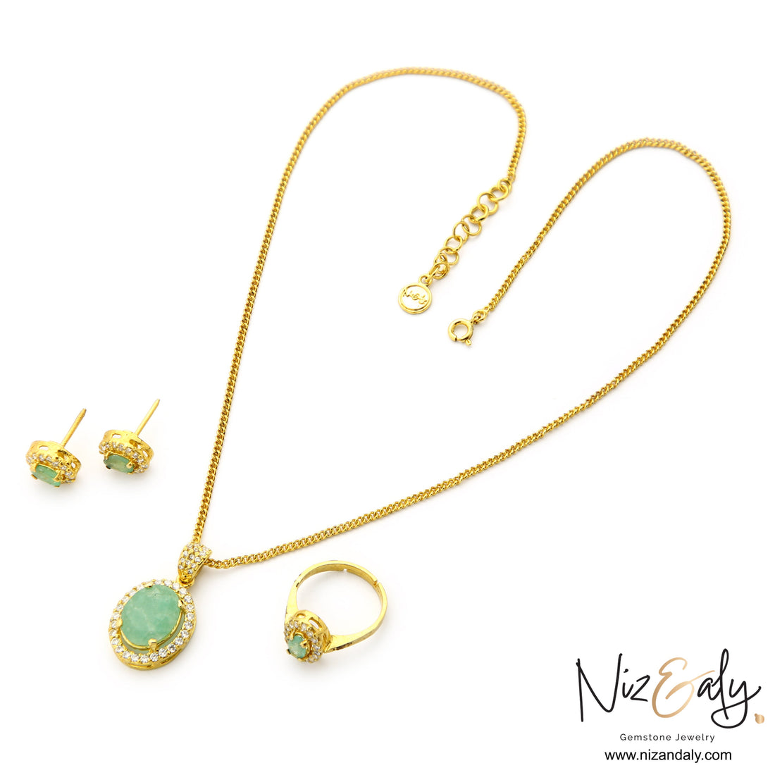 Niz & Aly Emeraude Halo jewelry set featuring oval natural emeralds in gold-plated sterling silver with clear stone halos.