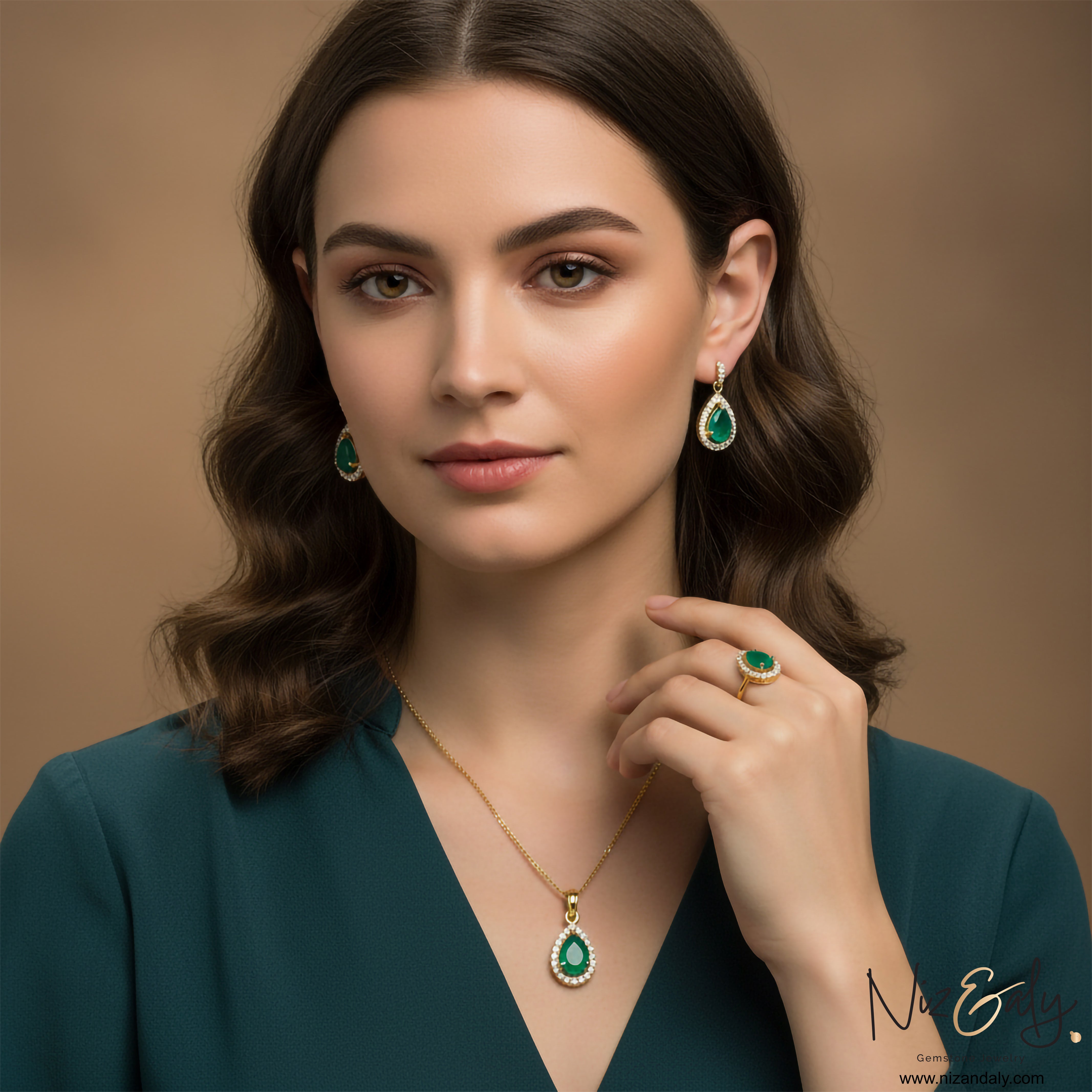 Niz & Aly natural teardrop emerald jewelry set with gold-plated sterling silver pendant, earrings, and ring on a model