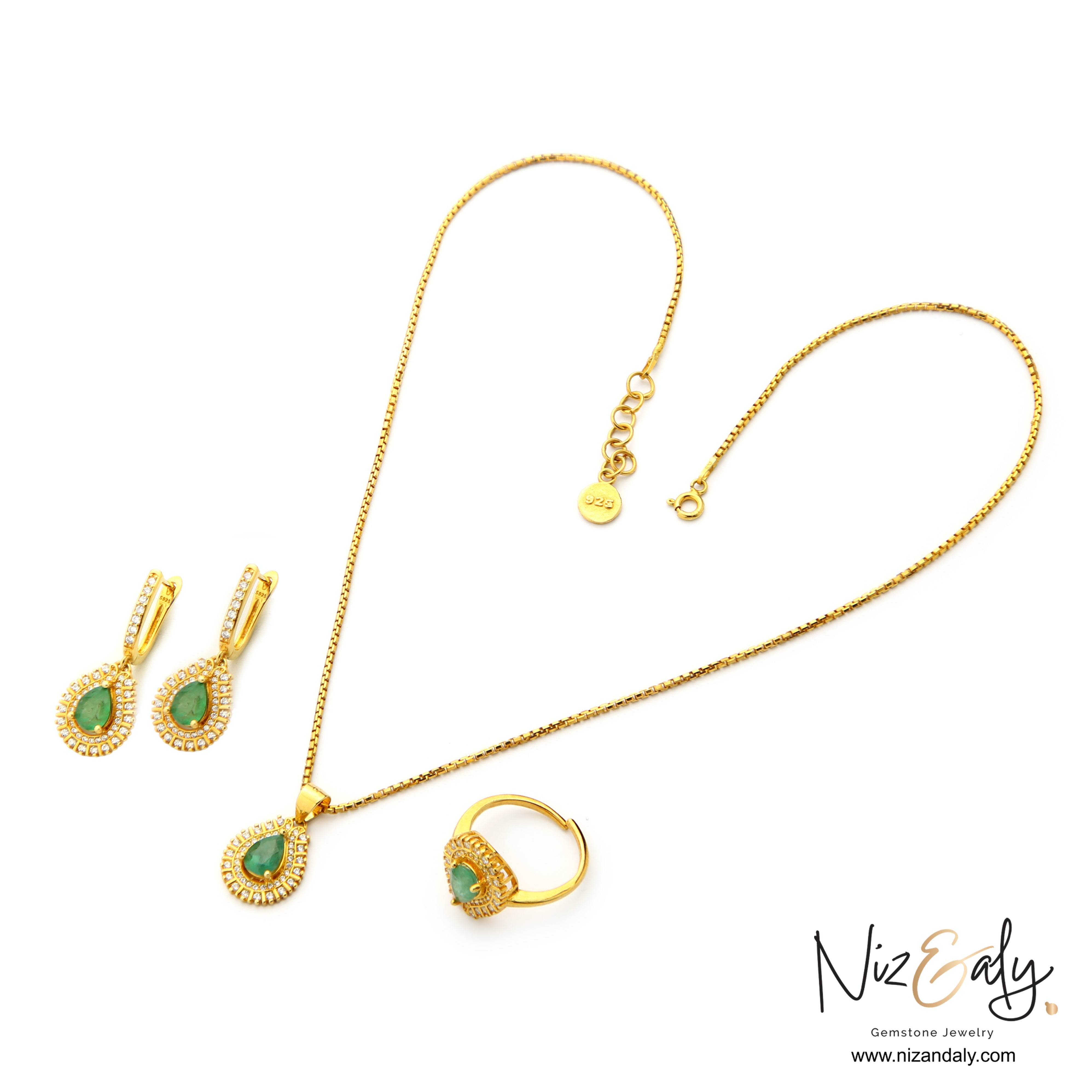 Niz & Aly Emerald Reverie jewelry set featuring teardrop emerald pendants, earrings, and ring in gold-plated silver.