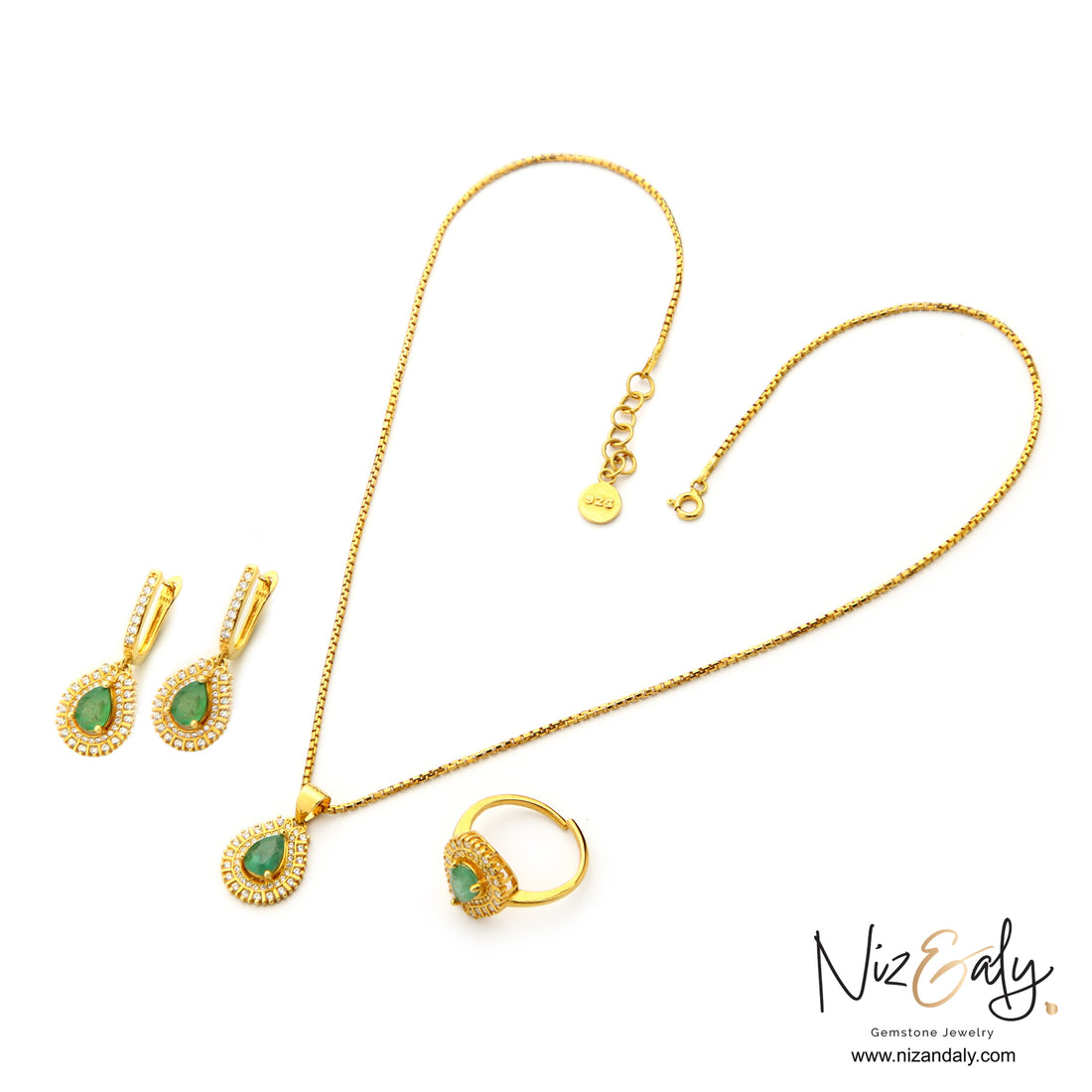 Niz & Aly Emerald Reverie jewelry set featuring teardrop emerald pendants, earrings, and ring in gold-plated silver.