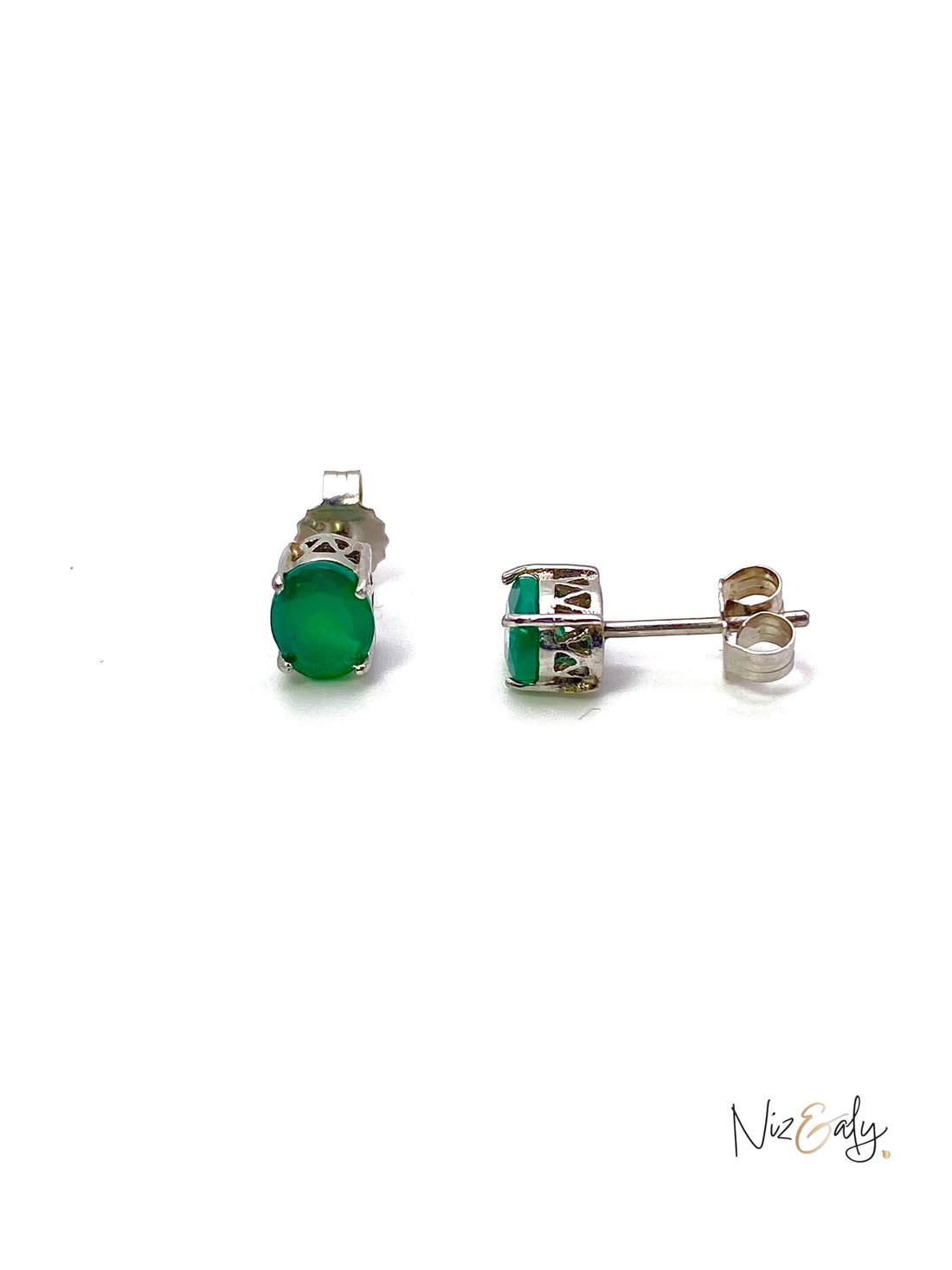 Niz & Aly dainty emerald stud earrings featuring vibrant green oval gemstones in a refined silver setting.