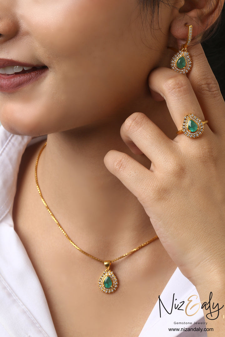 Niz & Aly emerald teardrop pendant, earrings, and ring set in gold-plated sterling silver with clear stone halos.