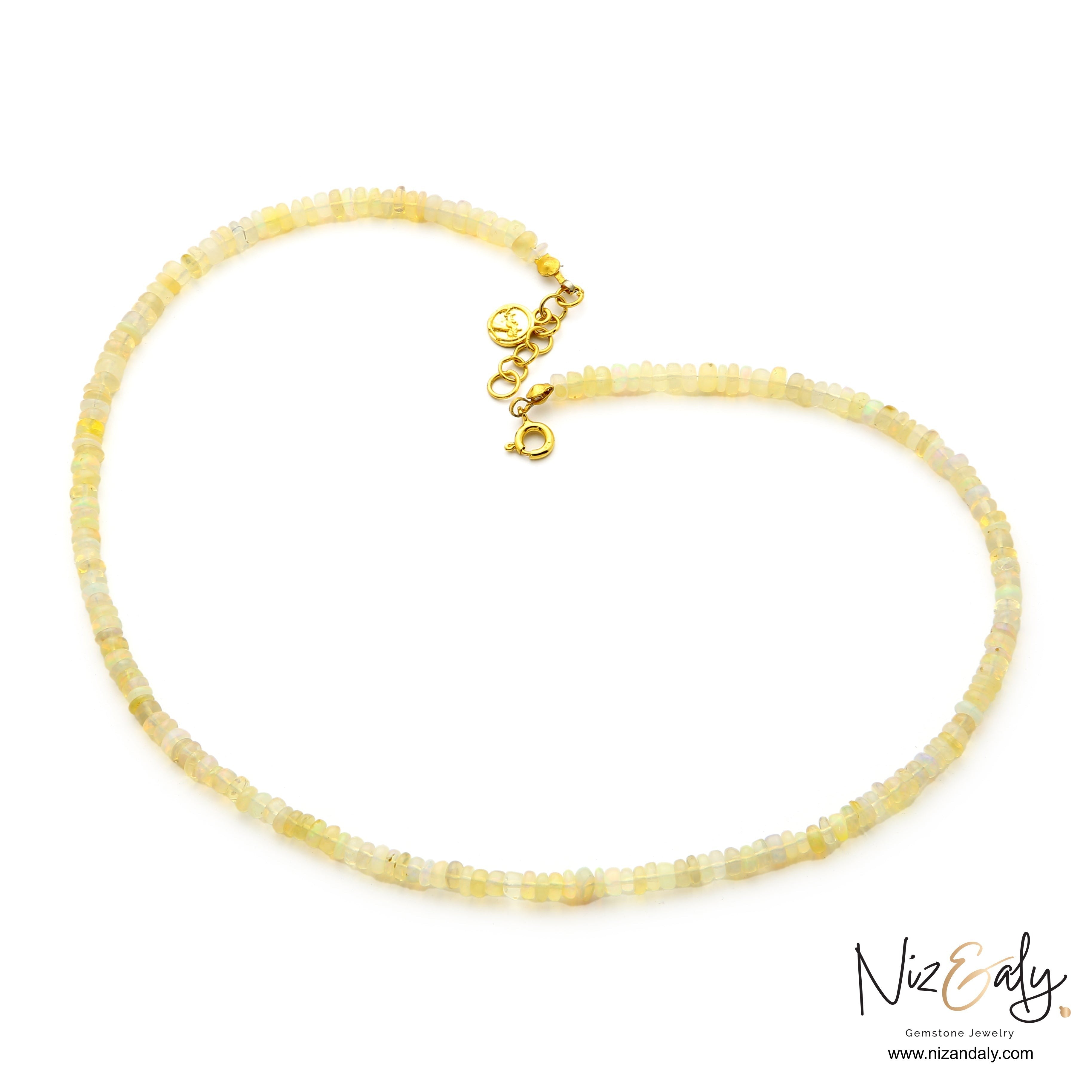 Niz & Aly Ethiopian fire opal rondelle bead necklace with gold-plated spring lock clasp on white background