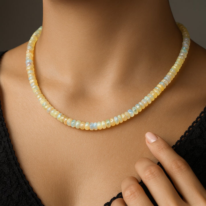 Niz & Aly 18-inch Ethiopian fire opal rondelle bead necklace with iridescent flashes worn on a model