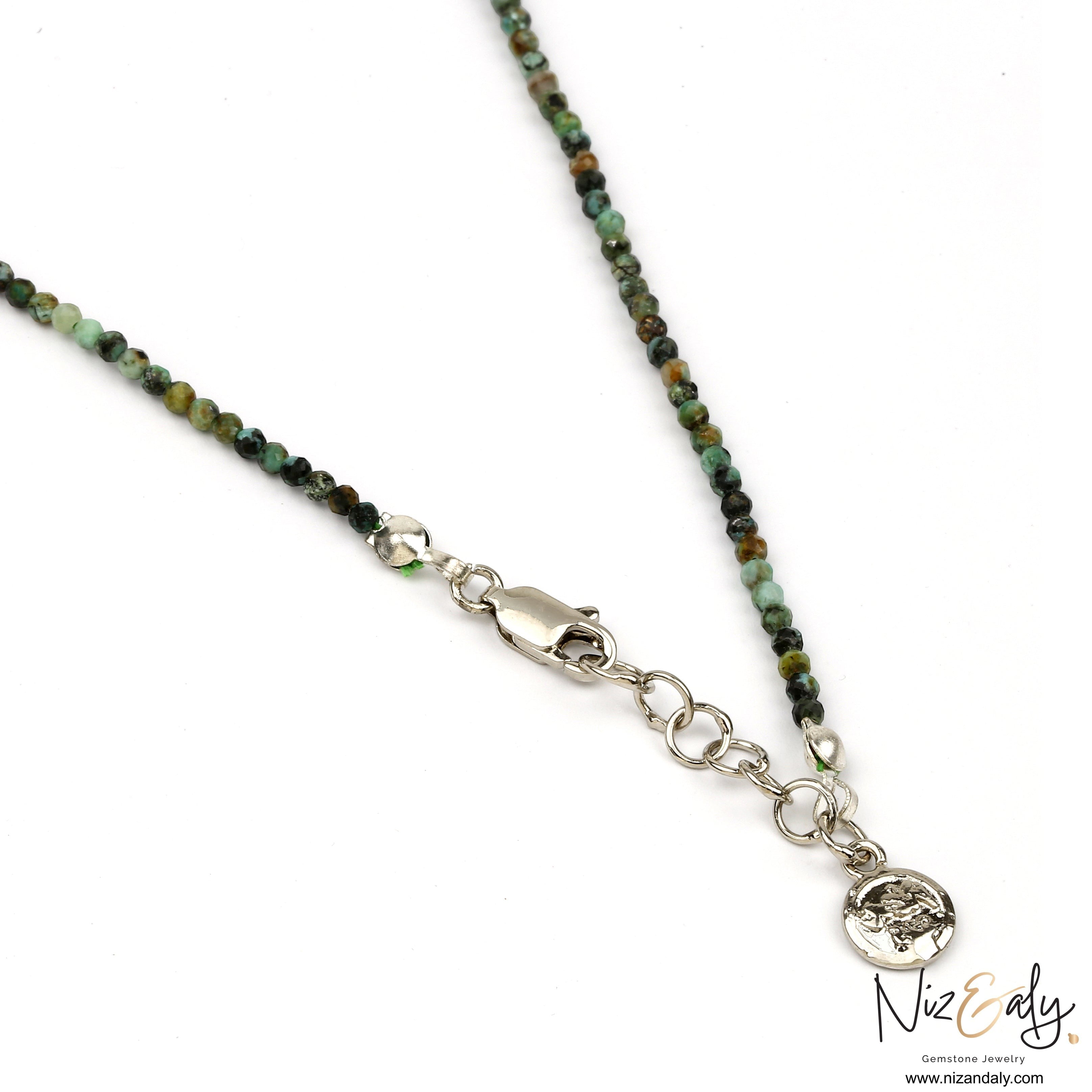 Niz & Aly dainty faceted African turquoise beaded necklace with silver clasp and charm detail on white background