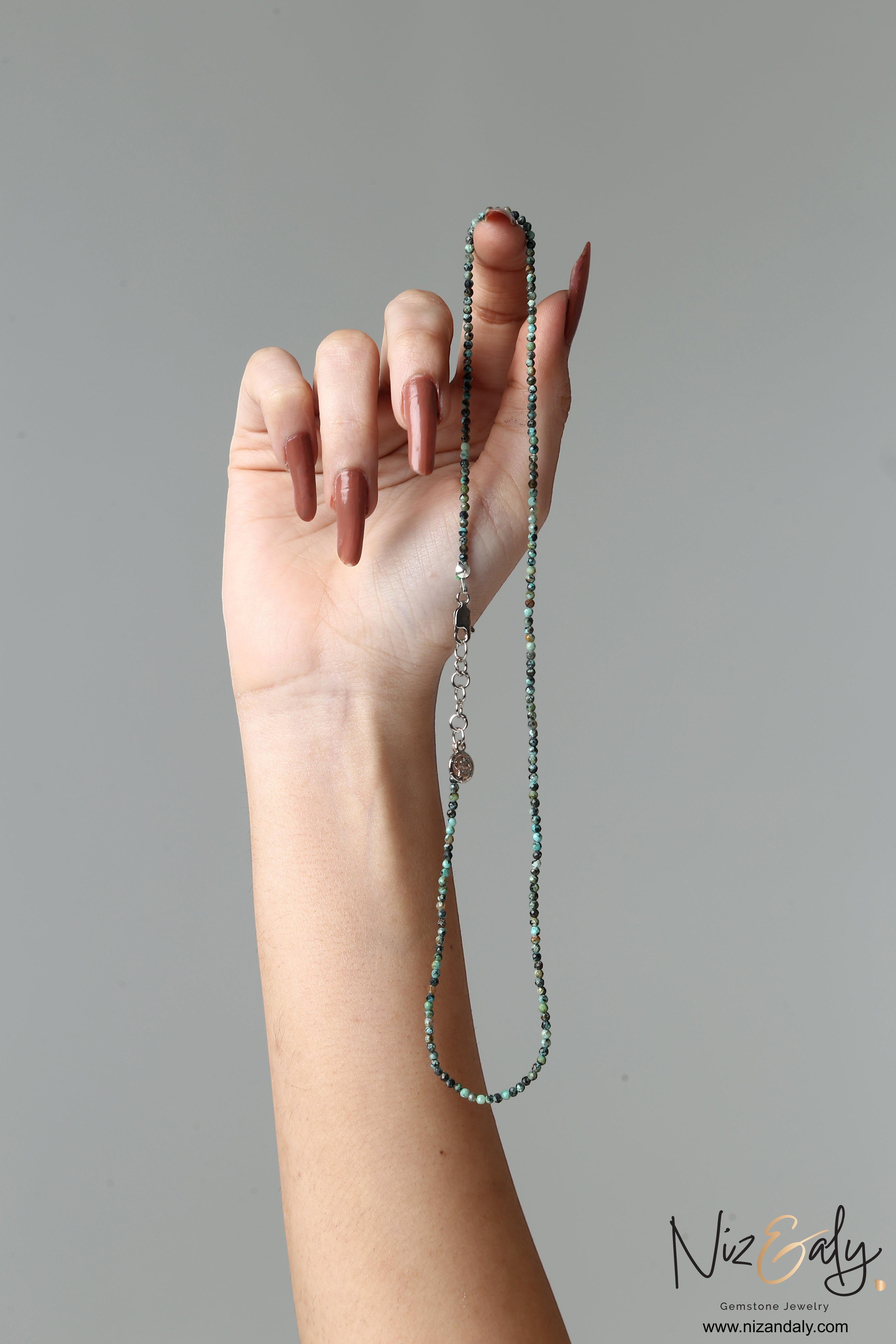 Niz & Aly dainty 16-inch necklace featuring 2mm faceted African turquoise beads with natural blue-green matrix patterns.