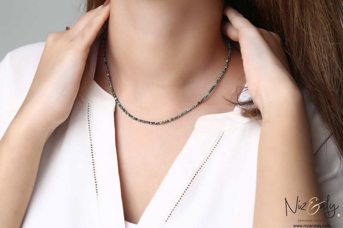 Niz & Aly dainty 16-inch necklace featuring 2mm faceted blue-green African turquoise beads on a woman's neck.