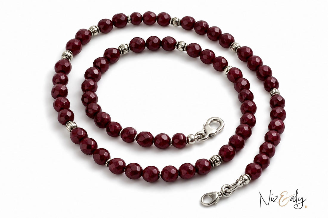 Niz & Aly faceted almandine garnet bead necklace with silver accents on a white background