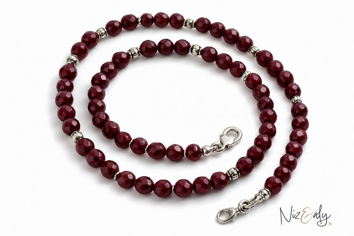 Niz & Aly faceted almandine garnet bead necklace with silver accents on a white background