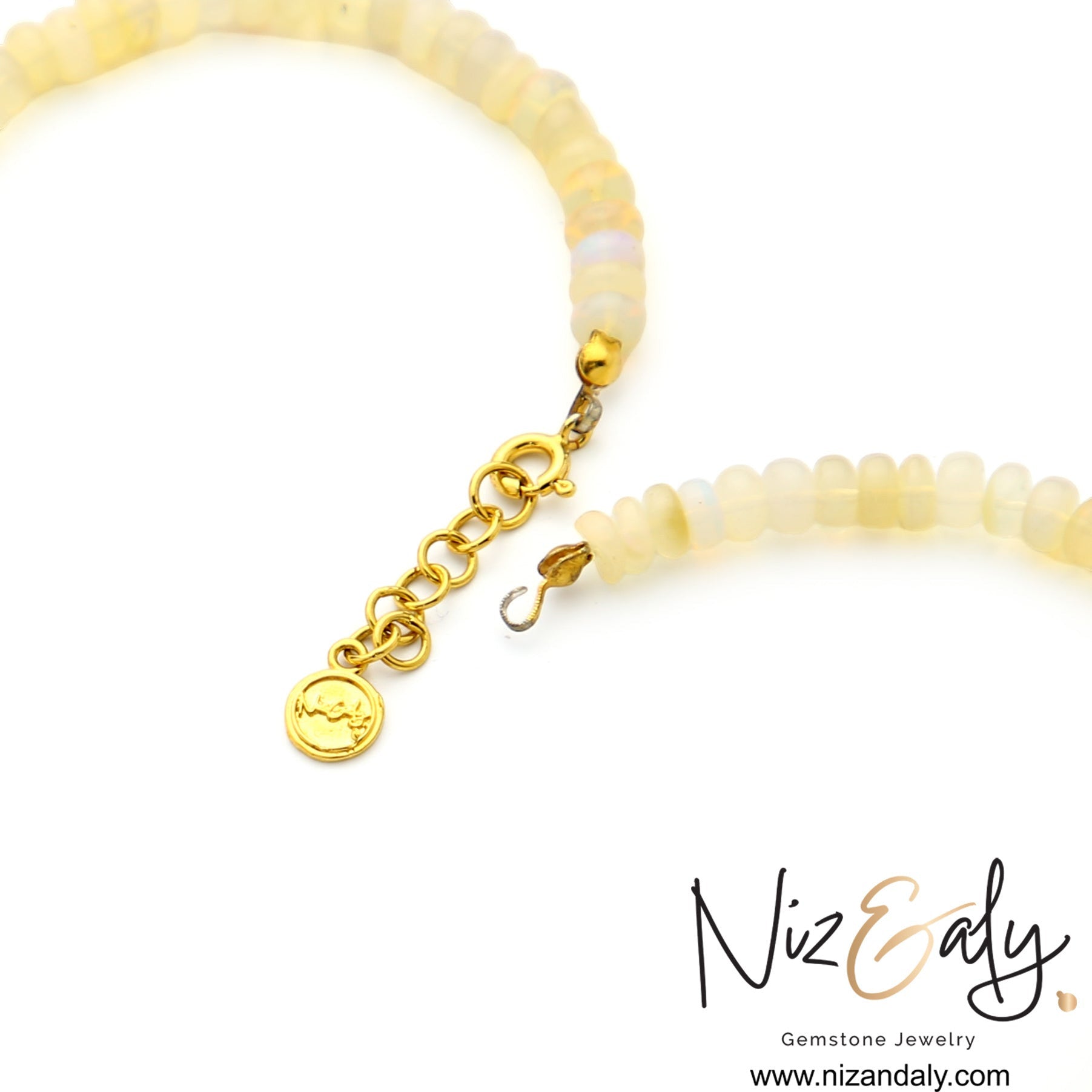 Niz & Aly Celestial Veil necklace featuring fire opal beads, gold clasp, and extender chain on white background.