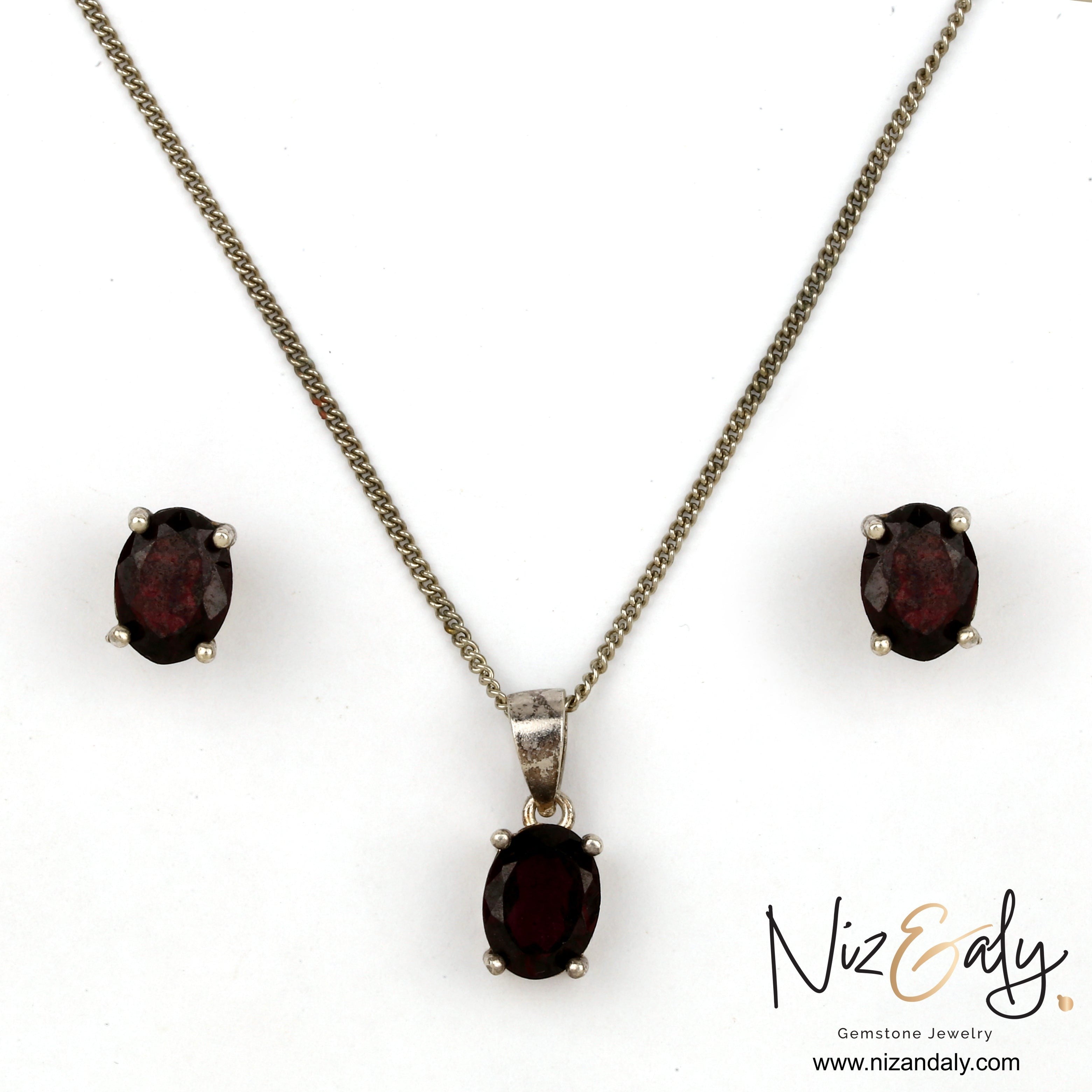Niz & Aly Garnet Locket Set featuring oval deep red garnet stones in silver settings with matching stud earrings