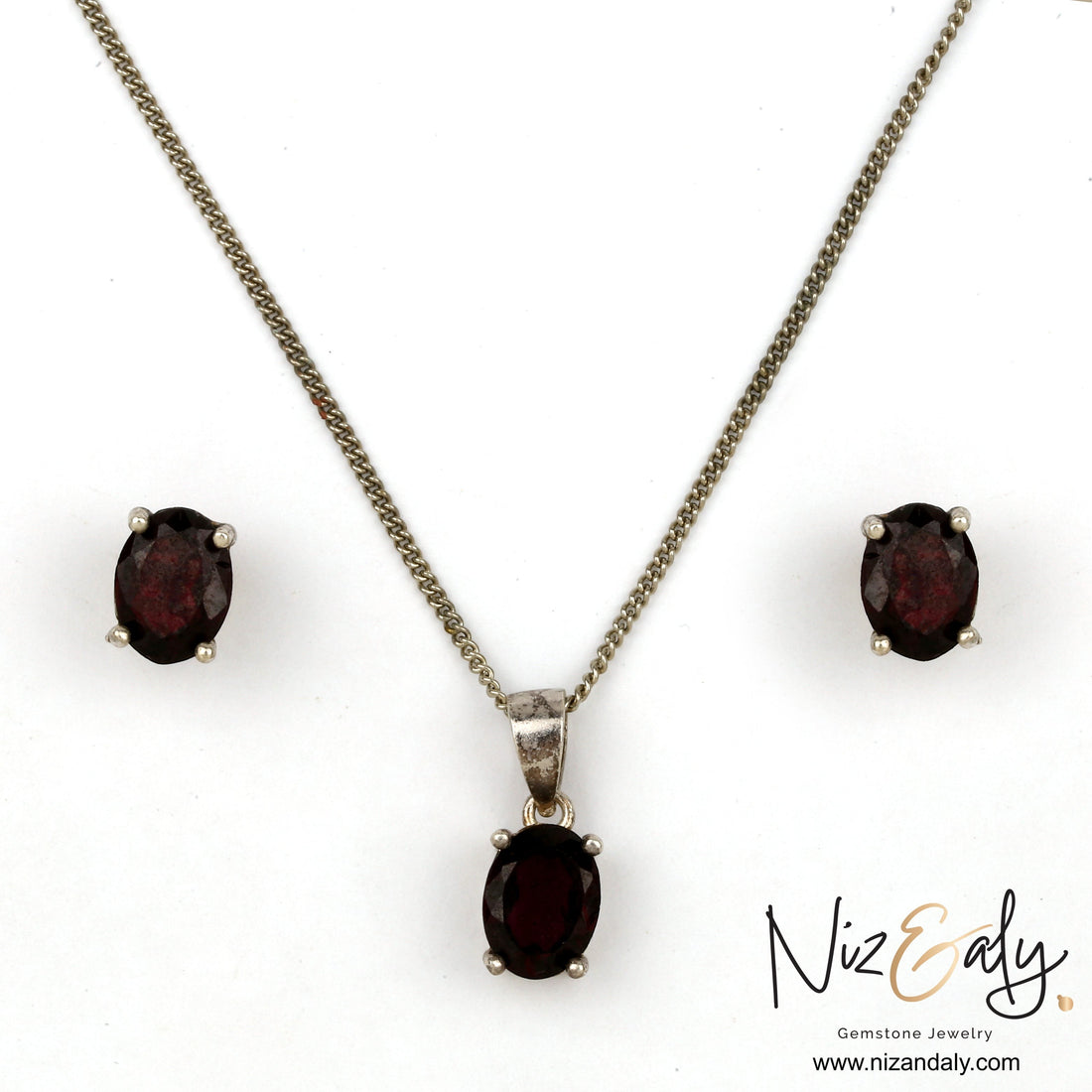Niz & Aly Garnet Locket Set featuring oval deep red garnet stones in silver settings with matching stud earrings