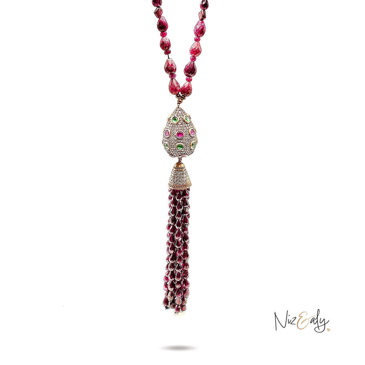 Niz & Aly Mozambique Almandine garnet tassel necklace featuring ruby accents and a diamond-encrusted decorative bead.